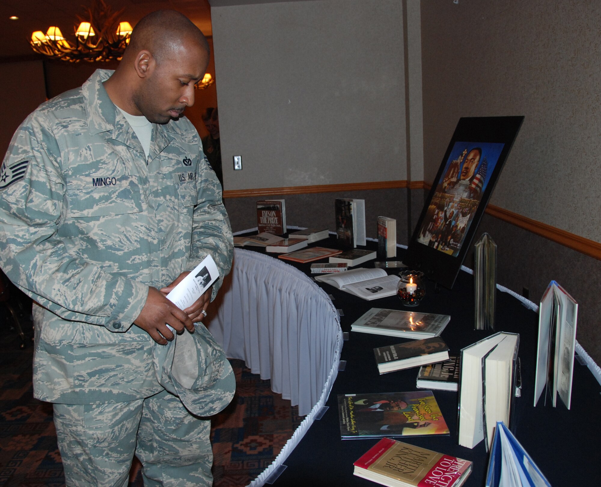 EIELSON AIR FORCE BASE, Alaska--Staff Sgt. Cornelius Mingo, 354th Force Support Squadron academic instructor, browses the display at the Martin Luther King, Jr. observance at the Yukon Club. Dr. King spent most of his life fighting for equal rights for not only African Americans, but for all mankind. (U.S. Air Force photo by Airman 1st Class Nora Anton)
