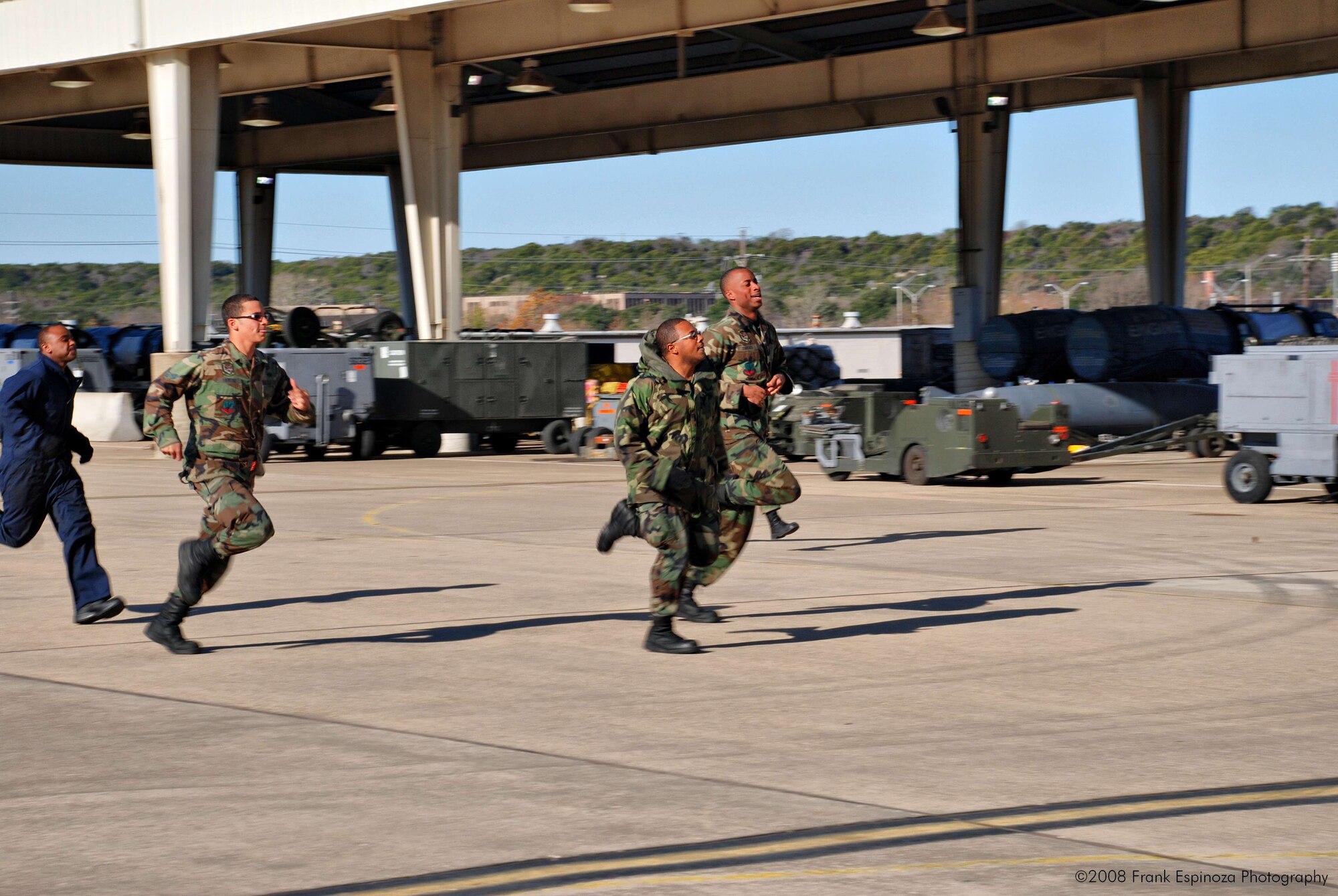 MOUNTAIN HOME AIR FORCE BASE, Idaho -- Airman 1st Class Tajwalid Priester, Airman 1st Class Devin Taylor, Airman 1st Class Justin Threats and Airman Jonathan Malone, 366th Aircraft Maintenance Squadron, run to prepare a jet for take-off during an alert. 100 Airmen from Mountain Home AFB deployed to Robert Gray Army Airfield at Fort Hood, Texas, as part of Operation Noble Eagle. The Airmen left Dec. 20 to provide air cover for the President during his Christmas vacation at his ranch in Crawford, Texas. The Airmen returned Jan. 2. (U.S. Air Force photo/ Tech. Sgt. Frank Espinoza)

