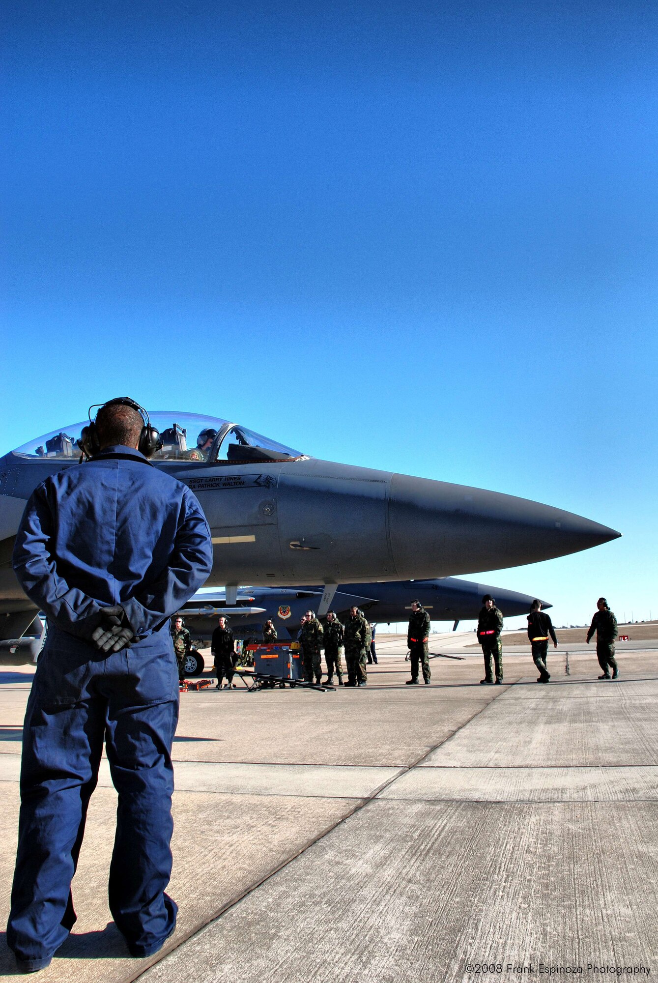 MOUNTAIN HOME AIR FORCE BASE, Idaho -- An Airman stands at parade rest as an F-15E from the 391st Fighter Squadron prepares to taxi to the runway. 100 Airmen from Mountain Home AFB deployed to Robert Gray Army Airfield at Fort Hood, Texas, as part of Operation Noble Eagle. The Airmen left Dec. 20 to provide air cover for the President during his Christmas vacation at his ranch in Crawford, Texas. The Airmen returned Jan. 2. (U.S. Air Force photo/ Tech. Sgt. Frank Espinoza)