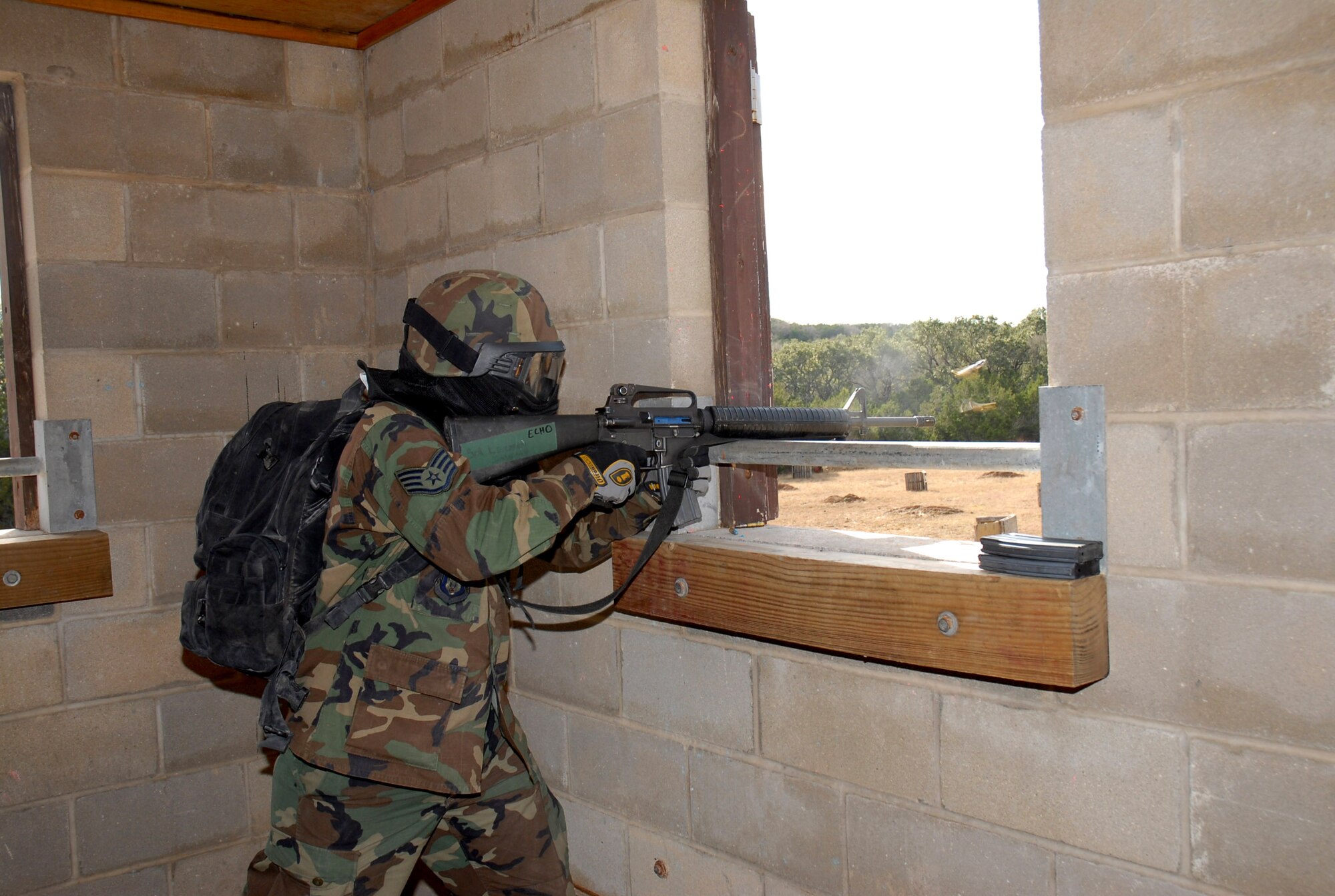 Instructor Staff Sgt. Felix Villarreal acts as an opposition force member during the final day of the Common Battlefield Airman Training Bridge course field training excercise Dec. 20 at Camp Bullis, Texas. Students use the skills taught to them throughout the week to maneuver into a hostile village. (U.S. Air Force photo/Staff Sgt. Beth Del Vecchio) 