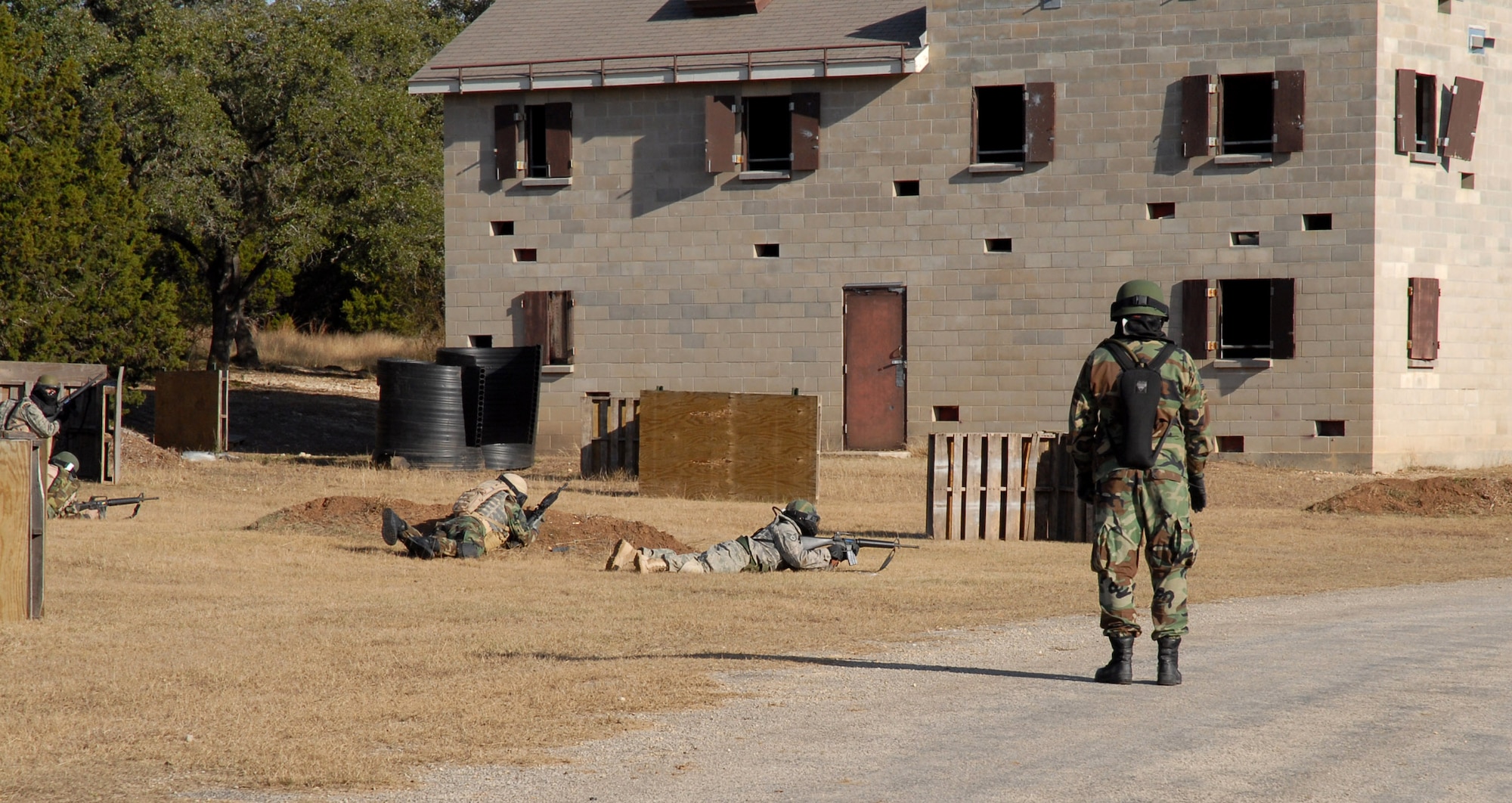 Students attending the Common Battlefield Airman Training Bridge course react to enemy fire as part of the final field training exercise Dec. 20 at Camp Bullis, Texas. Students use skills taught throughout the week to successfully maneuver into a village. (U.S. Air Force photo/Staff Sgt. Beth Del Vecchio) 


