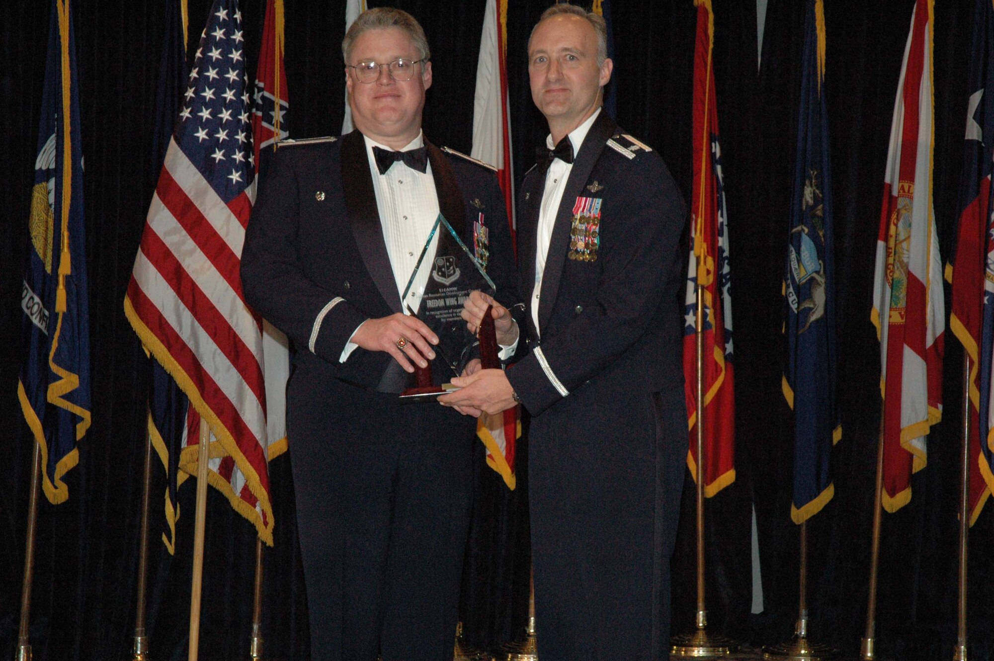 MCGUIRE AIR FORCE BASE, N.J. -- Commander Lt. Col. Thomas L. Ayers of the 78th Aerial Refueling Squadron accepts the Unit Level Human Resources Development Council Freedom Wing Award 2007 from Col. James L. Kerr, commander, 514th Air Mobility Wing. The New Jersey Reserve unit held its 8th annual awards banquet Jan. 12 at The Club on base. (U.S. Air Force photo/Senior Airman William P. O'Neil III)