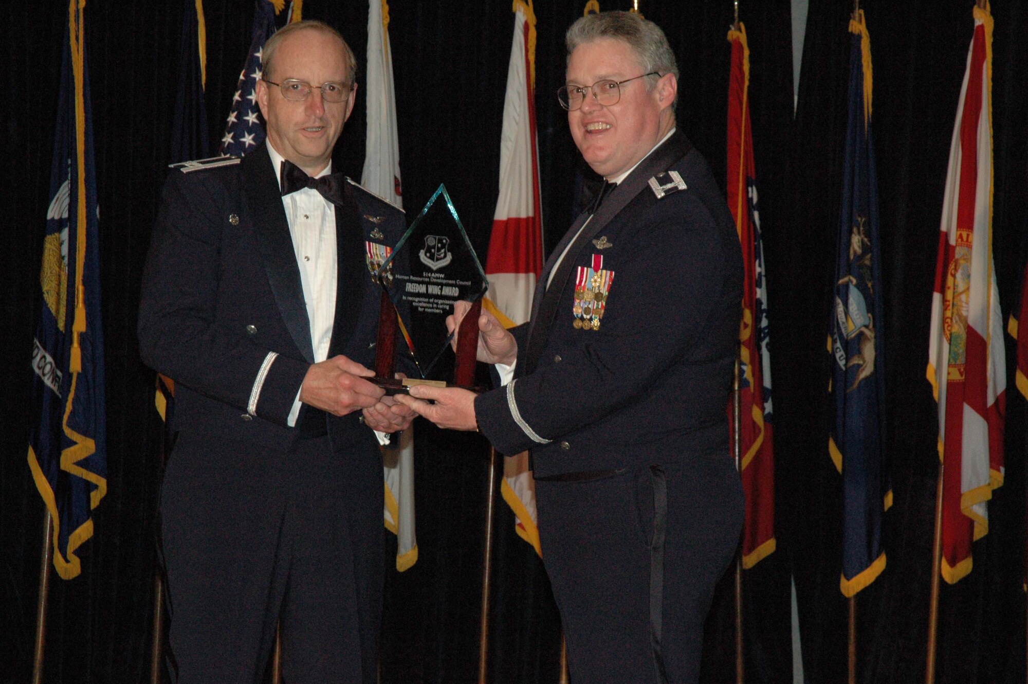 MCGUIRE AIR FORCE BASE, N.J. -- Commander Col. Ellie F. Nix of the 514th Mission Support Group accepts the Group Level Human Resources Development Council Freedom Wing Award 2007 from Col. James L. Kerr , commnader , 514th Air Mobility Wing. The New Jersey Reserve unit held its 8th annual awards banquet Jan. 12 at The Club on base. (U.S. Air Force photo/Senior Airman William P. O'Neil III)