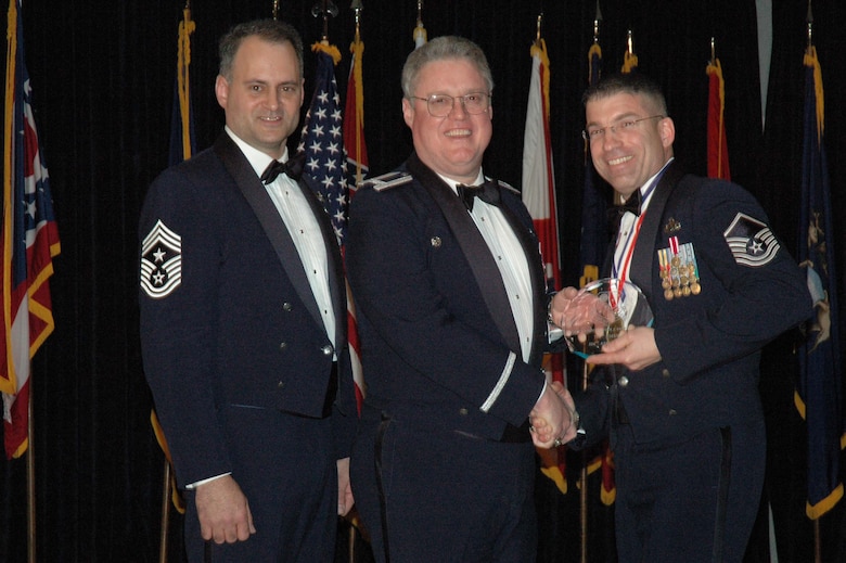MCGUIRE AIR FORCE BASE, N.J. -- Master Sgt. Christopher J. Hofrichter, right, of the 714th Aircraft Maintenance Squadron receives the 514th Air Mobility Wing Senior Noncommissioned Officer of the Year 2007 from Commander Col. James L. Kerr, middle and Command Chief Master Sgt. Michael J. Ferraro, left, Jan. 12 during the Reserve wing's 8th annual awards banquet. (U.S. Air Force photo/Senior Airman William P. O'Neil III)