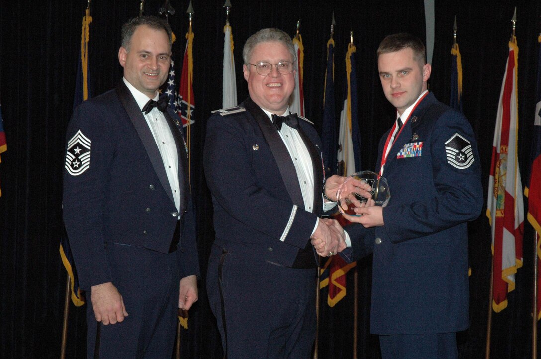 MCGUIRE AIR FORCE BASE, N.J. -- Master Sgt. Michael B. Moody, right, of the 514th Maintenance Squadron receives the 514th Air Mobility Wing Noncommissioned Officer of the Year 2007 Award from Commander Col. James L. Kerr, middle and Command Chief Master Sgt. Michael J. Ferraro, left, Jan. 12 during the Reserve wing's 8th Annual Awards Banquet. (U.S. Air Force photo/Senior Airman William P. O'Neil III)