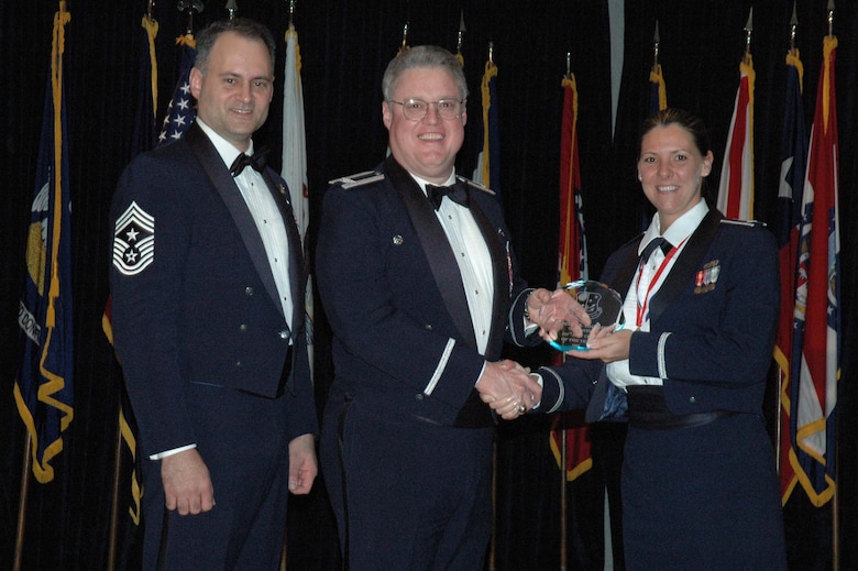 MCGUIRE AIR FORCE BASE, N.J. -- 1st Lt. Rebecca K. Daugherty, right, of the 714th Aircraft Maintenance Squadron receives the 514th Air Mobility Wing Company Grade Officer of the Year 2007 Award from Commander Col. James L. Kerr, middle and Command Chief Master Sgt. Michael J. Ferraro, left, Jan. 12 during the Reserve wing's 8th annual awards banquet. (U.S. Air Force photo/Senior Airman William P. O'Neil III)