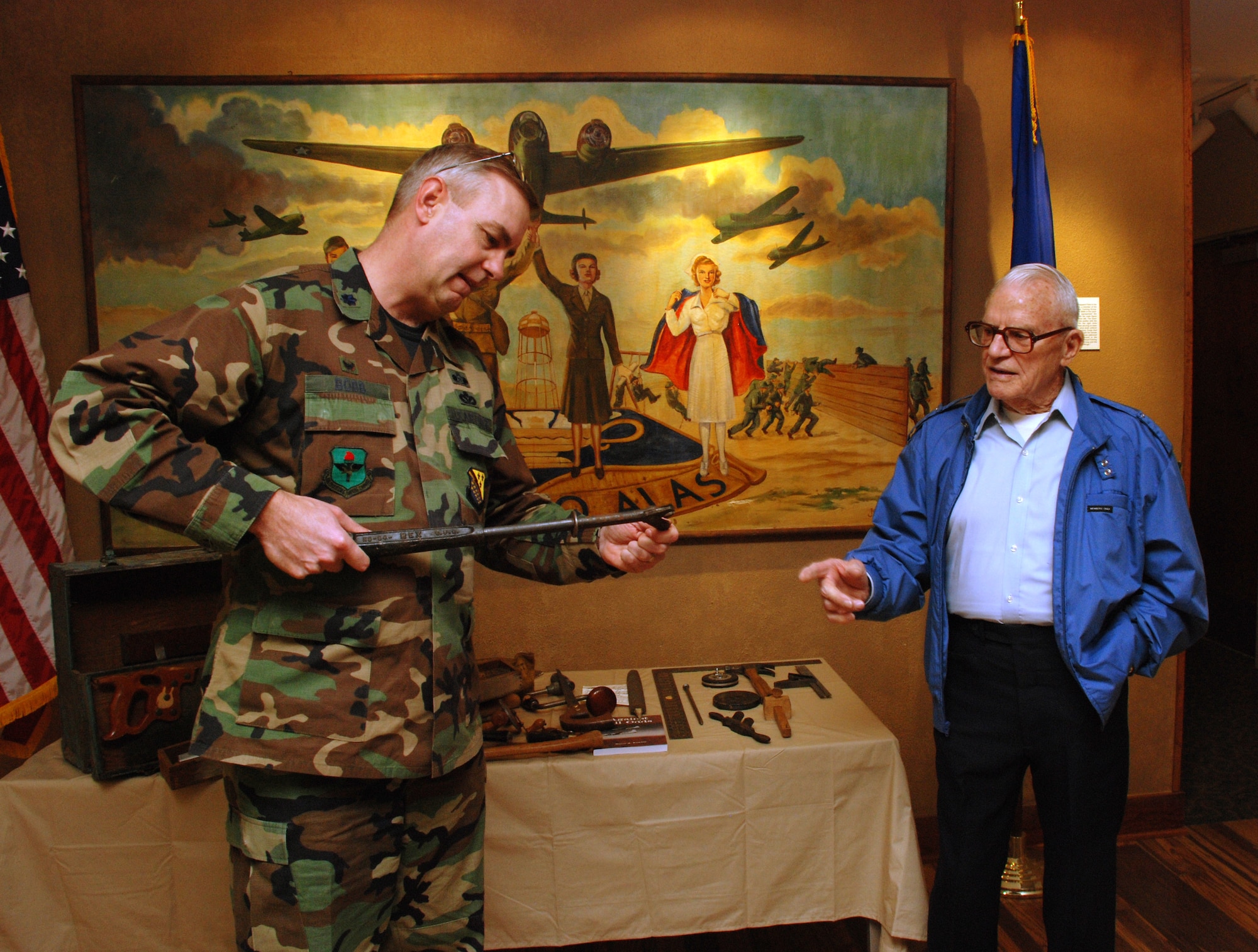 Retired Maj. Wayne Kuschel explains the use of a World War II era carpenter's tool to Lt. Col. Matthew Bobb, 366th Training Squadron commander, Jan. 16 at the base Heritage Center. The tool was only one part of a WWII era tool kit which was donated by Major Kuschel and will be put on display at the structural apprentice course school house at Det. 6 366th TRS in Gulfport, Miss.  (U.S. Air Force photo/Airman 1st Class Jacob Corbin)