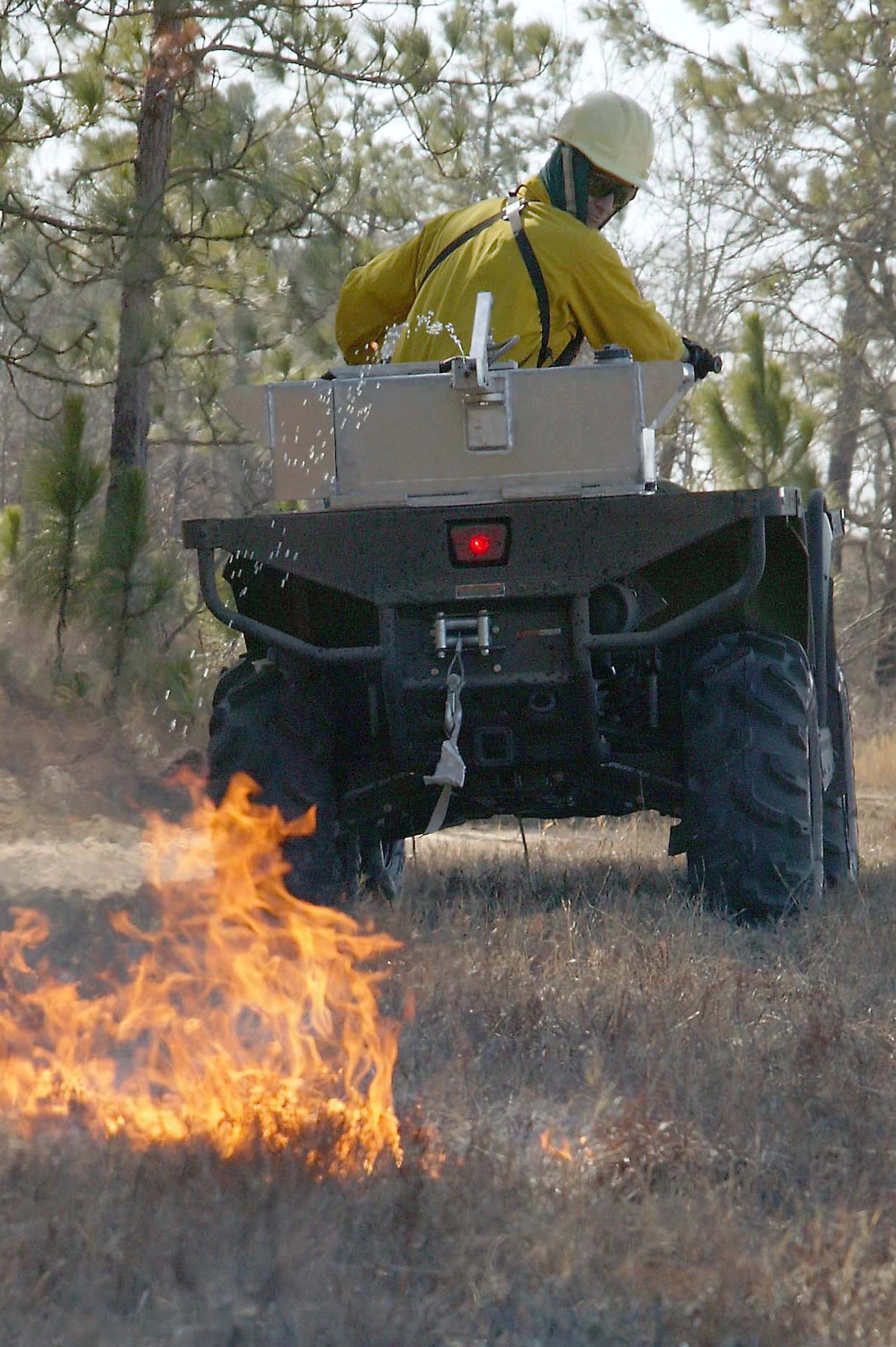 SHAW AIR FORCE BASE, S.C. -- Mr. Ronnie June, 20th Civil Engineer Squadron natural resources planner, starts a fire using a gasoline and diesel mixture during a prescribed burn at Poinsett Electronic Combat Range Jan. 15. The main purpose for the prescribed burn is fuel reduction and to provide training for the 20th CES Fire Department. Approximately 52 acres were burned to prevent wildfires. (U.S. Air Force photo/Staff Sgt. John Gordinier)