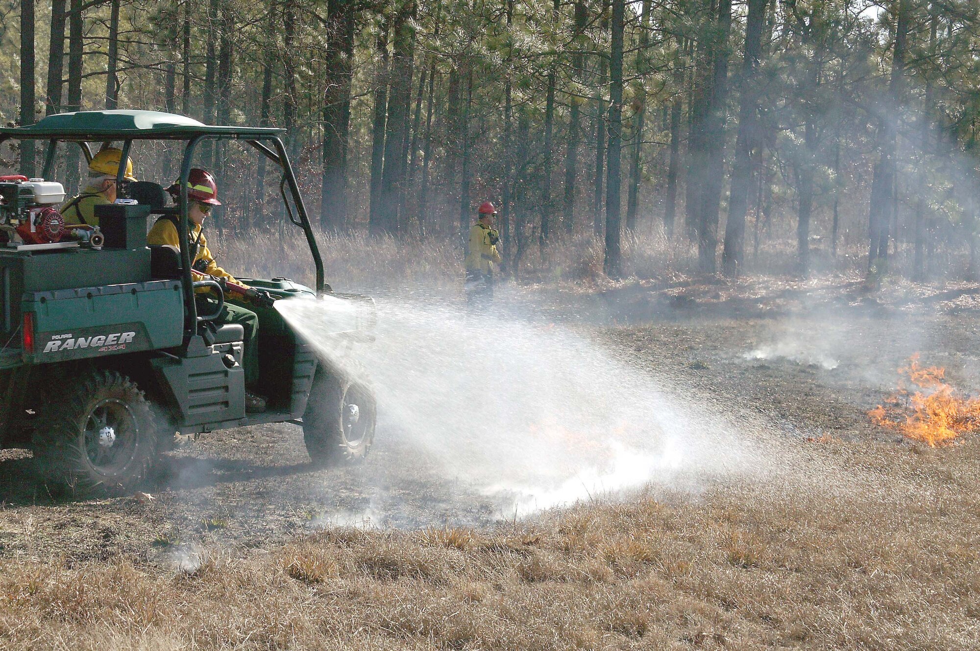 SHAW AIR FORCE BASE, S.C. -- Ms. Julie Hovis, 20th Civil Engineer Squadron endangered species manager, extinguishes the flames during a prescribed fire at Poinsett Electronic Combat Range Jan. 15. The main purpose for the prescribed burn is fuel reduction and to provide training for the 20th CES Fire Department. Approximately 52 acres were burned to prevent wildfires. (U.S. Air Force photo/Staff Sgt. John Gordinier)
