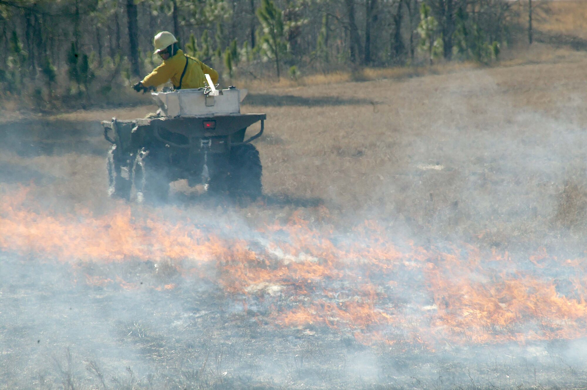 SHAW AIR FORCE BASE, S.C. -- Mr. Ronnie June, 20th Civil Engineer Squadron natural resources planner, starts a fire using a gasoline and diesel mixture during a prescribed burn at Poinsett Electronic Combat Range Jan. 15. The main purpose for the prescribed burn is fuel reduction and to provide training for the 20th CES Fire Department. Approximately 52 acres were burned to prevent wildfires. (U.S. Air Force photo/Staff Sgt. John Gordinier)