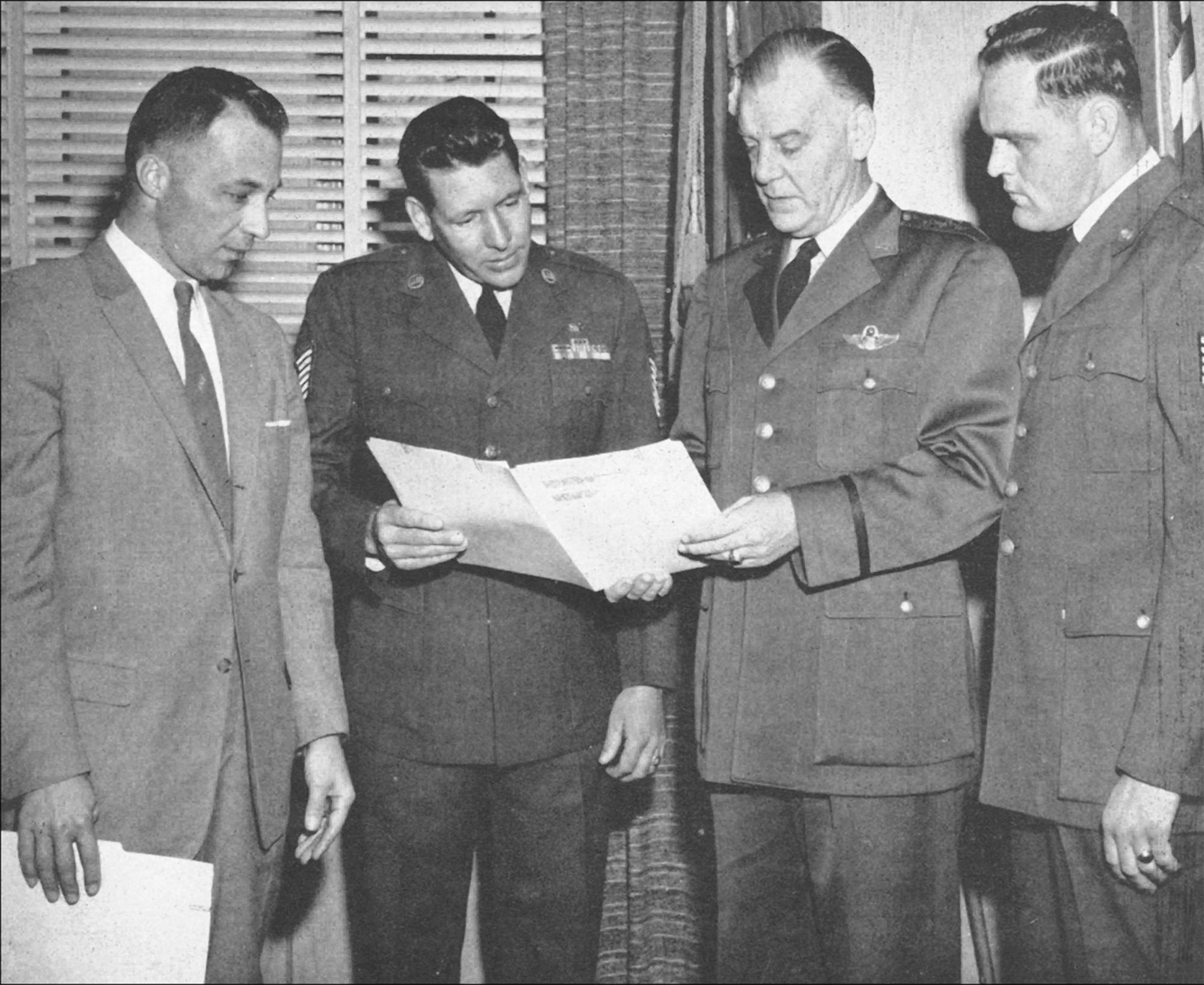 Lt. Gen. William E. Hall (third from left), Continental Air Command commander, swears in Master Sgt. Samuel C. McCormack (second from left) and Tech. Sgt. James W. Clark as the first two air reserve technicians. Looking on is L.C. (Lee) Lingelbach, CONAC director of civilian personnel. 