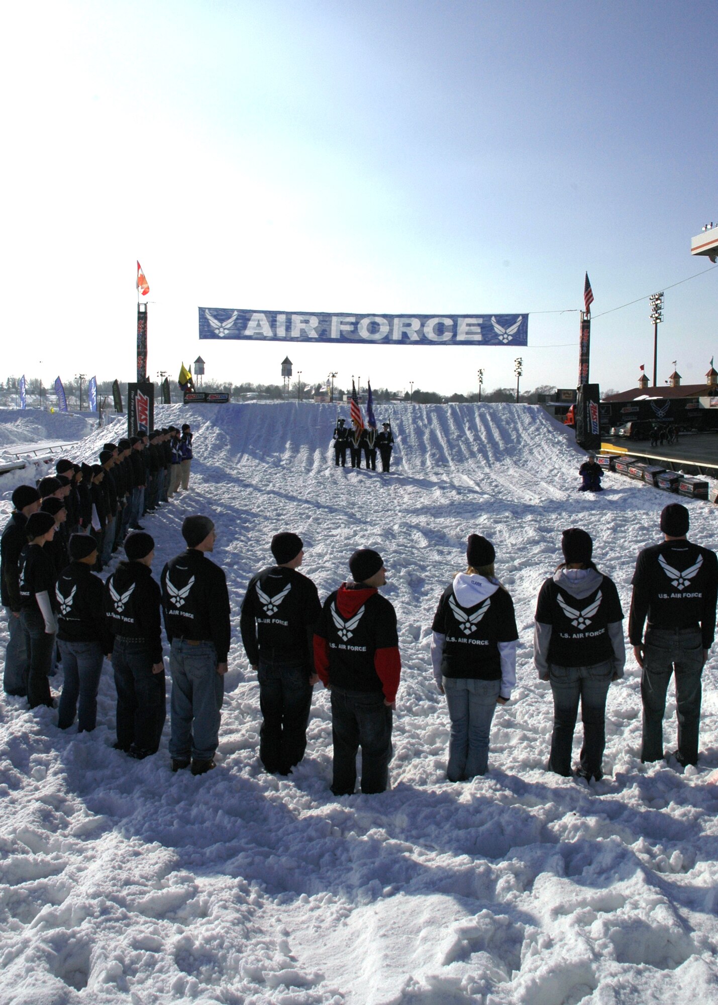 Thirty-four Air Force Delayed Enlistment Program members, who are waiting to enlist, watch as Air Force Honor Guard post the colors at a Jan. 12 SnoCross event in Shakopee, Minn.