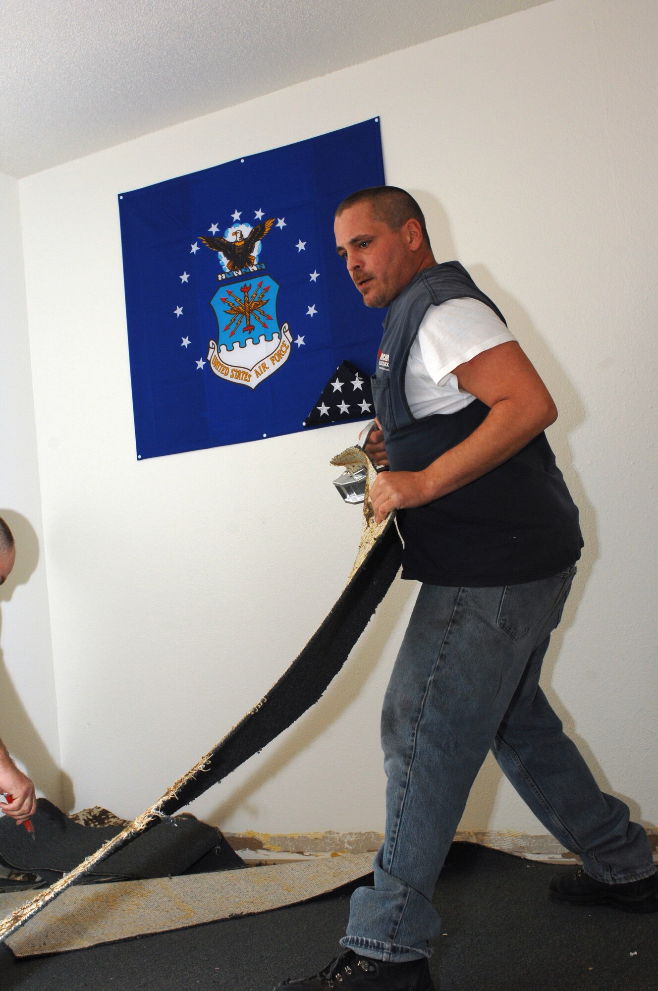 CANNON AIR FORCE BASE, N.M. - James Meintzer tears up a strip of a carpet in a dorm room in Dorm 1245. The carpet in the dorm is being replaced and upon completion Dorm 1161's carpet is scheduled to be finished as well. (U.S. Air Force photo by Airman 1st Class Evelyn Chavez)
