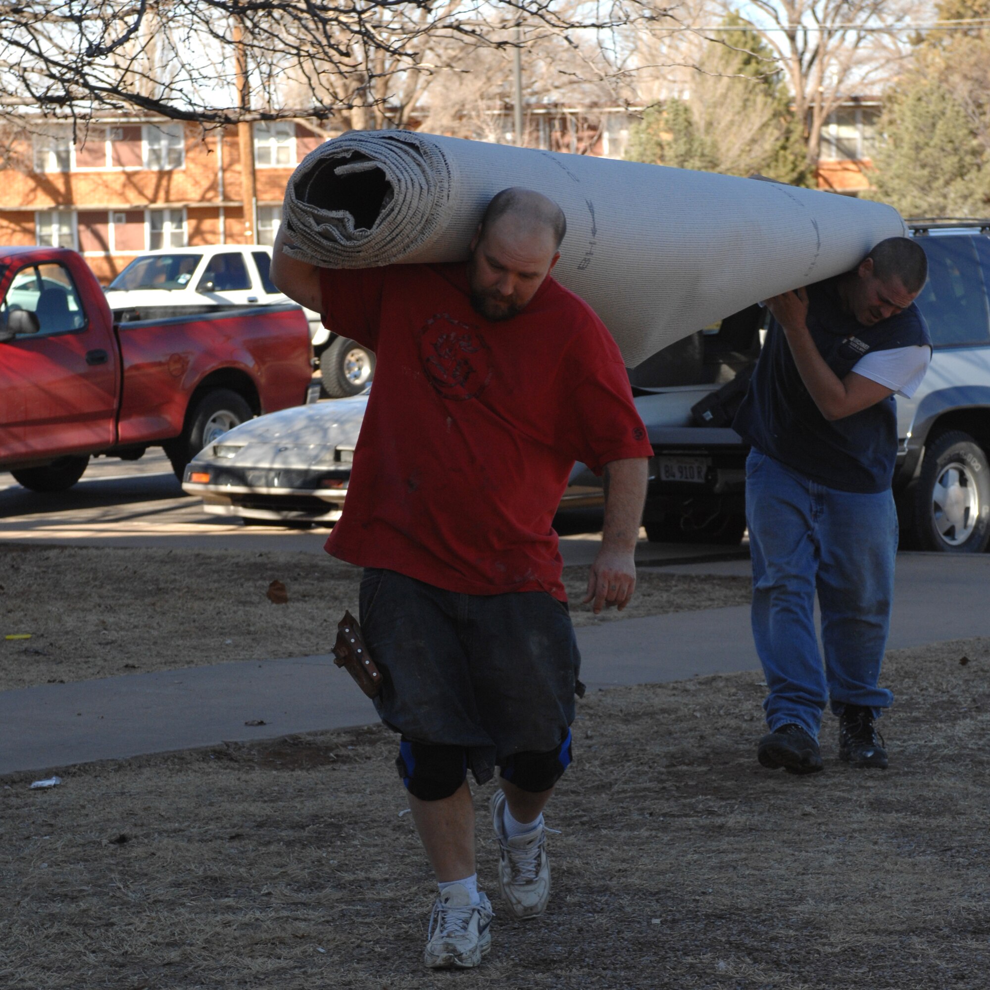 CANNON AIR FORCE BASE, N.M. - James Gleason (left) and James Meintzer bring a roll of carpet into Dorm 1245. The carpet in the dorm is being replaced and upon completion Dorm 1161's carpet is scheduled to be finished as well. (U.S. Air Force photo by Airman 1st Class Evelyn Chavez)