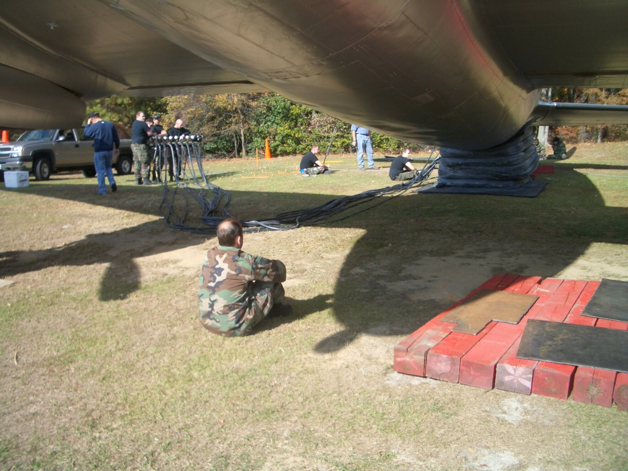 Tech. Sgt. Steven Brack, 43rd Maintenance Squadron, monitors the lifting of the C-46 Commando with pneumatic lift bags. Pope's 43rd MXS crash recovery team repaired the static for Fort Bragg's 82nd Airborne Park Nov. 17, 2007. 
