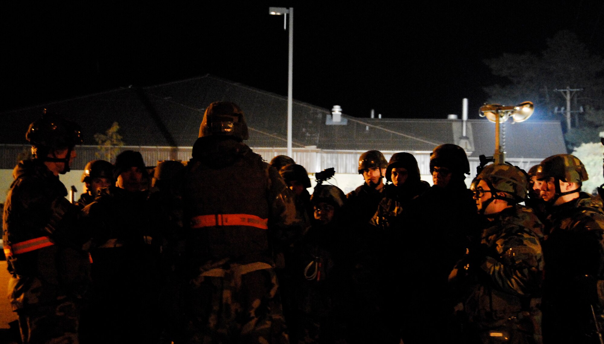 KUNSAN AIR BASE, South Korea -- Members of the 8th Security Forces Squadron gather for an out brief after a stimulated opposition forces attack during a peninsula wide operations readiness exercise (PENORE) here Jan 17.  The PENORE is conducted to ensure members of the Wolf Pack remain ready to execute the mission of maintaining peace and stability in the region.  (U.S. Air Force photo/Tech Sgt. Quinton T. Burris)