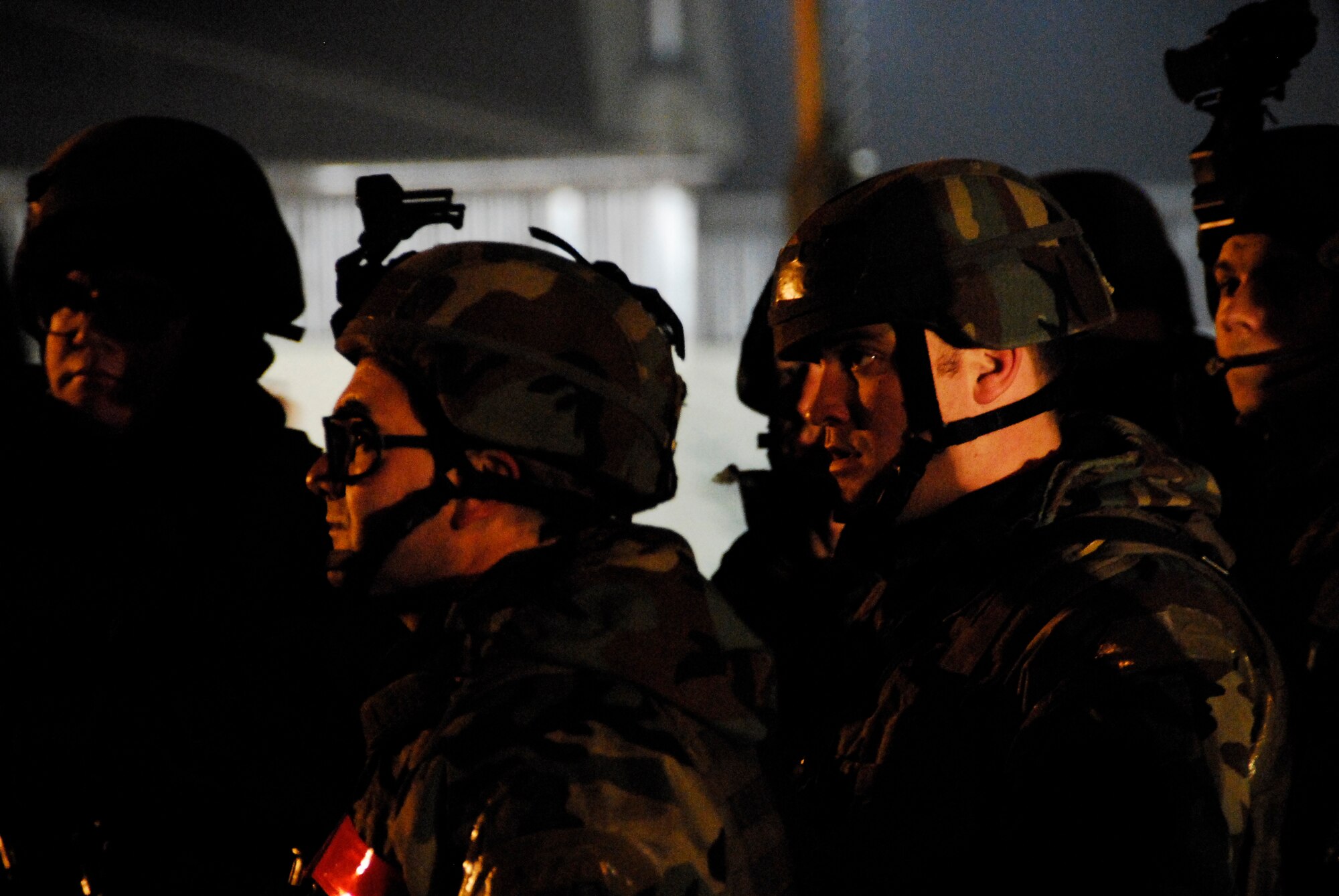 KUNSAN AIR BASE, South Korea -- Members of the 8th Security Forces Squadron gather for an out brief after a stimulated opposition forces attack during a peninsula wide operations readiness exercise (PENORE) here Jan 17.  The PENORE is conducted to ensure members of the Wolf Pack remain ready to execute the mission of maintaining peace and stability in the region.  (U.S. Air Force photo/Tech Sgt. Quinton T. Burris)