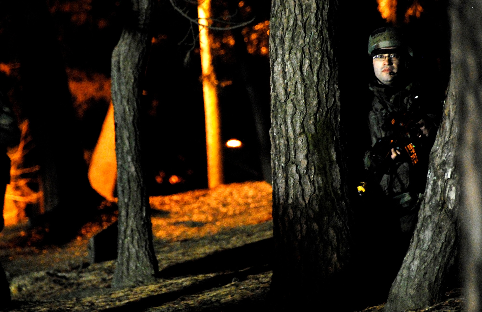 KUNSAN AIR BASE, South Korea -- A member of the 8th Security Force Squadron reacts to an opposition forces attack during a peninsula wide operations readiness exercise (PENORE) here Jan 17.  The PENORE is conducted to ensure members of the Wolf Pack remain ready to execute the mission of maintaining peace and stability in the region.  (U.S. Air Force photo/Tech Sgt. Quinton T. Burris)