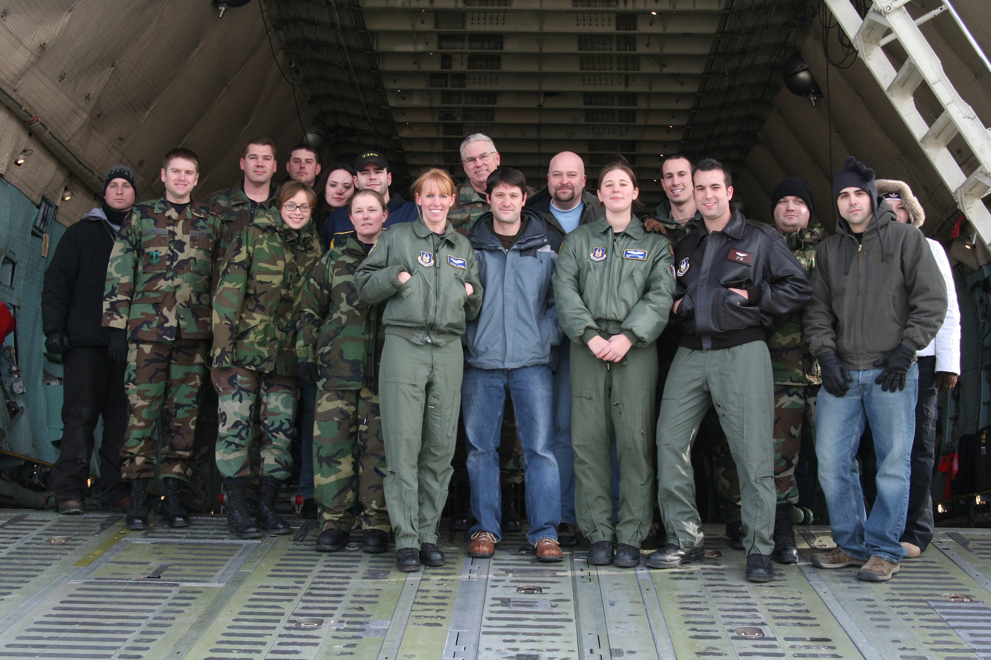 WRIGHT-PATTERSON AFB, Ohio - 445th Airlift Wing members take a moment for a group shot with the Ghost Hunters cast on a C-5. The popular Sci Fi Channel T.V. show Ghost Hunters is filming their show in several buildings at Wright-Patterson AFB and filmed some footage of the 445th Airlift Wing's C-5 Galaxy Jan. 15, 2008, to help enhance the Air Force base setting for the show. (U.S. Air Force photo/Laura Darden)