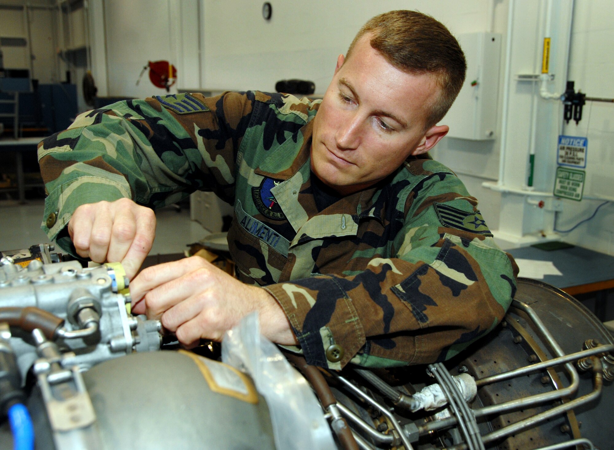 PATRICK AIR FORCE BASE, Fla. -- Staff Sgt. John Alimenti, a Reservist with the 920th Rescue Wing propulsion shop here, secures the igniter assembly on T-701C engine, used on the H-60 Pave Hawk helicopter. The propulsion shop is responsible for inspecting and removing engines, replacing bad components, then reinstalling and performing efficientcy tests. The Pave Hawks, along with pararescuemen and HC-130P/N refuelers, are part of the triad of assets used by the 920th for combat search and rescue, NASA launch support, civilian search and rescue, and humanitarian relief. (U.S. Air Force photo/Master Sgt. Chance C. Babin)