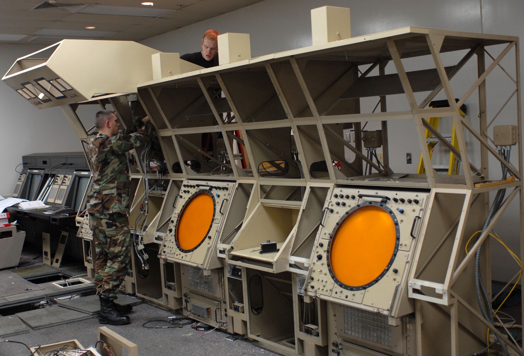 WHITEMAN AIR FORCE BASE, Mo. - Staff Sgt. Matthew Speaks and Matthew Ebright, 509th Communications Squadron, dismantle the old ATC radar equipment to make room for STARS. (Photo by Robert Breshears, printed with permission)