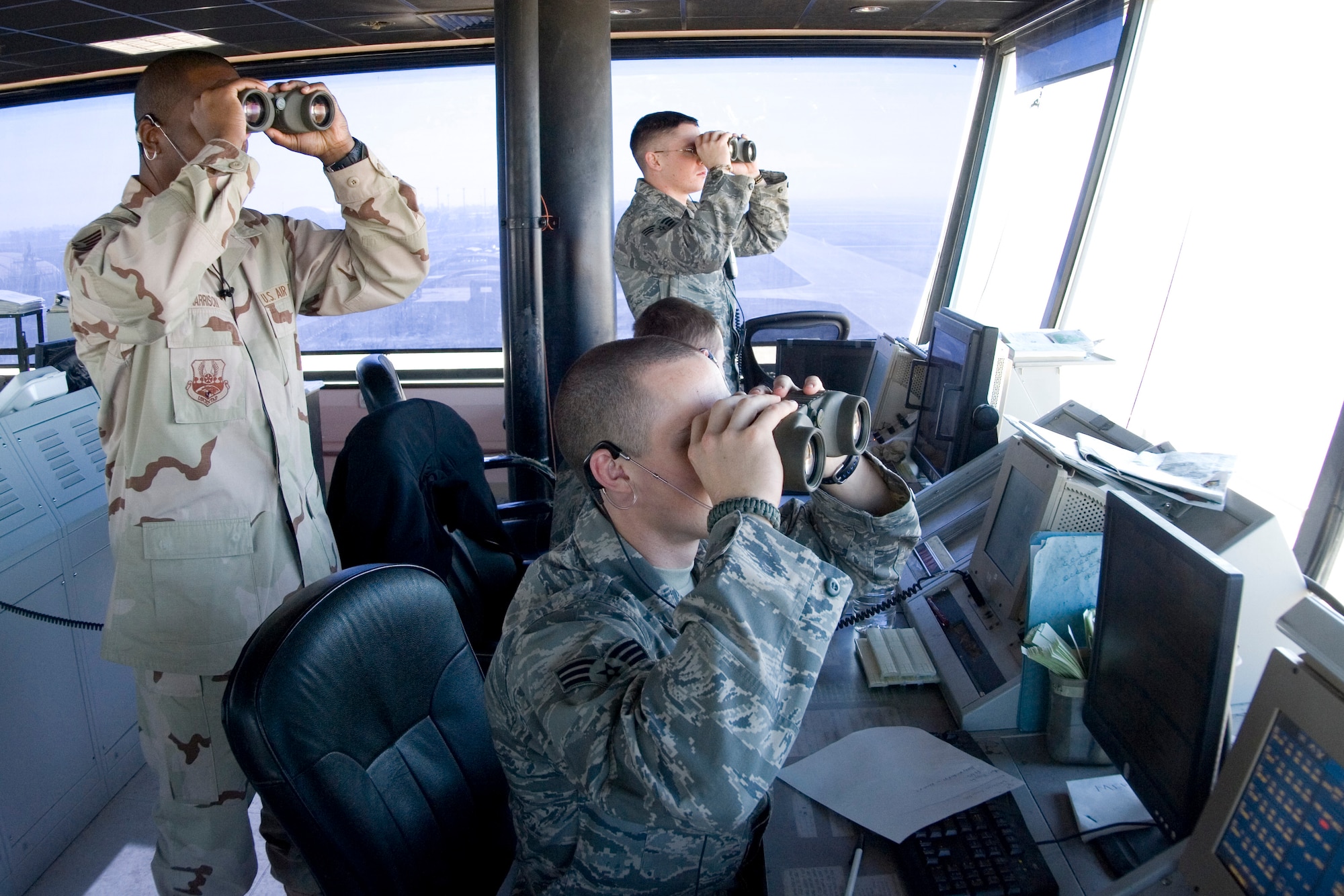 BALAD AIR BASE, Iraq -- Air traffic controllers use binoculars to watch the takeoff of a small unmanned aerial vehicle from across the runway here, Jan. 17. Balad controllers oversee the busiest single runway in the Department of Defense. (U.S. Air Force photo/ Staff Sgt. Travis Edwards)