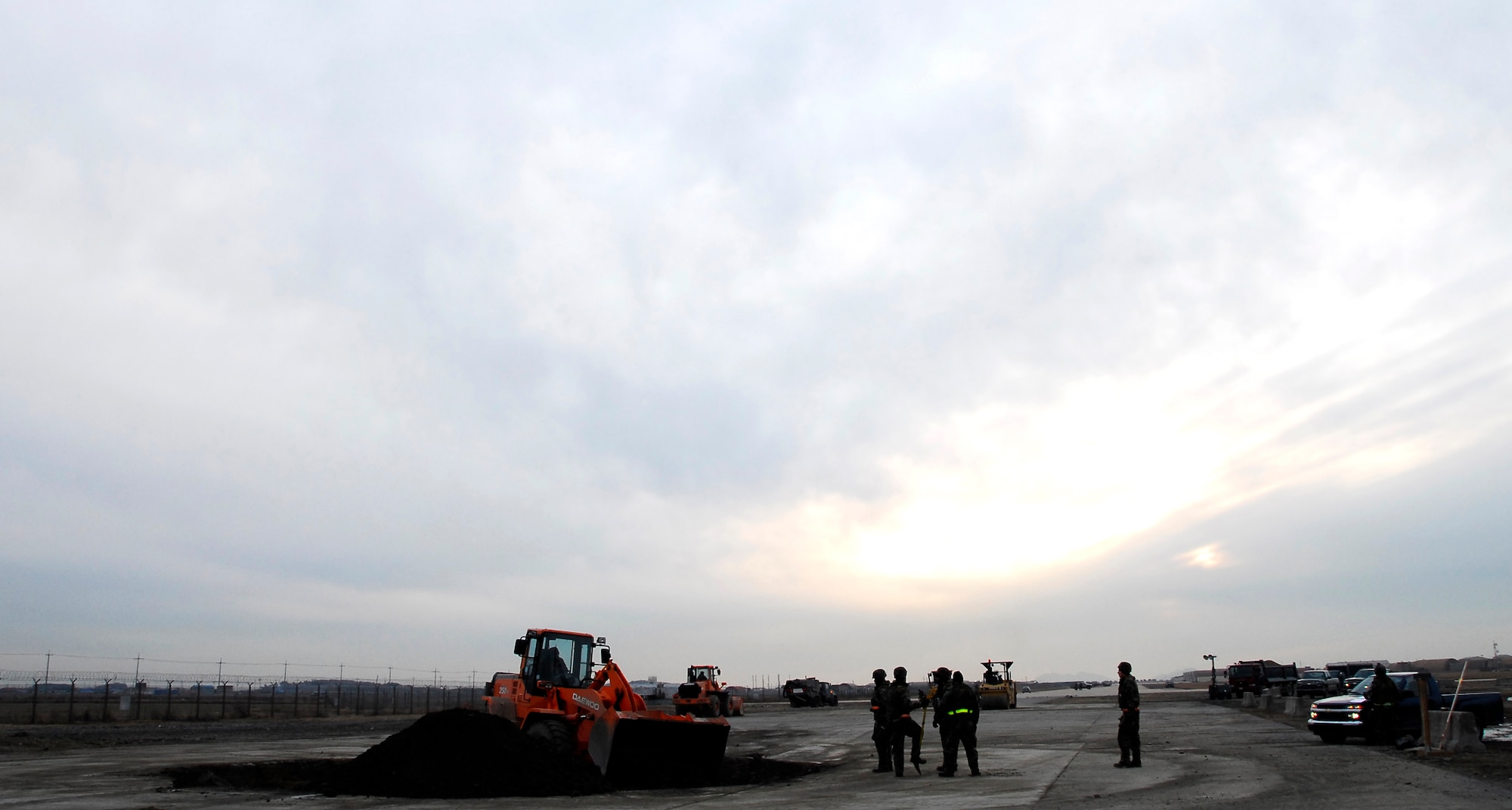 KUNSAN AIR BASE, South Korea -- Members of the 8th Civil Engineer Squadron conduct airfield damage repair during a peninsula wide operations readiness exercise (PENORE) here Jan 17.  The PENORE is conducted to ensure members of the Wolf Pack remain ready to execute the mission of maintaining peace and stability in the region.  (U.S. Air Force photo/Tech Sgt. Quinton T. Burris)