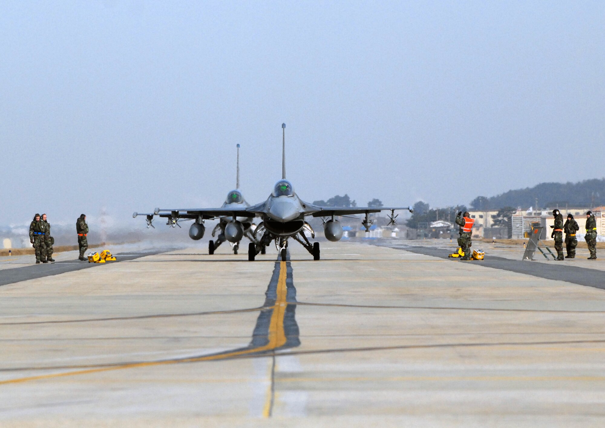 KUNSAN AIR BASE, South Korea -- F-16 Fighting Falcon's from the 35th Fighter Squadron and 111th Republic of Korea Air Force Fighter Squadron, taxi on the runway for joint flying operations during the peninsula wide operations readiness exercise here Jan. 17. The exercise is conducted to ensure members of the Wolf Pack remain ready to execute its mission of "Defending the Base, Accepting Follow on Forces and Taking the Fight North." (U.S. Air Force photo/Senior Airman Steven R. Doty)