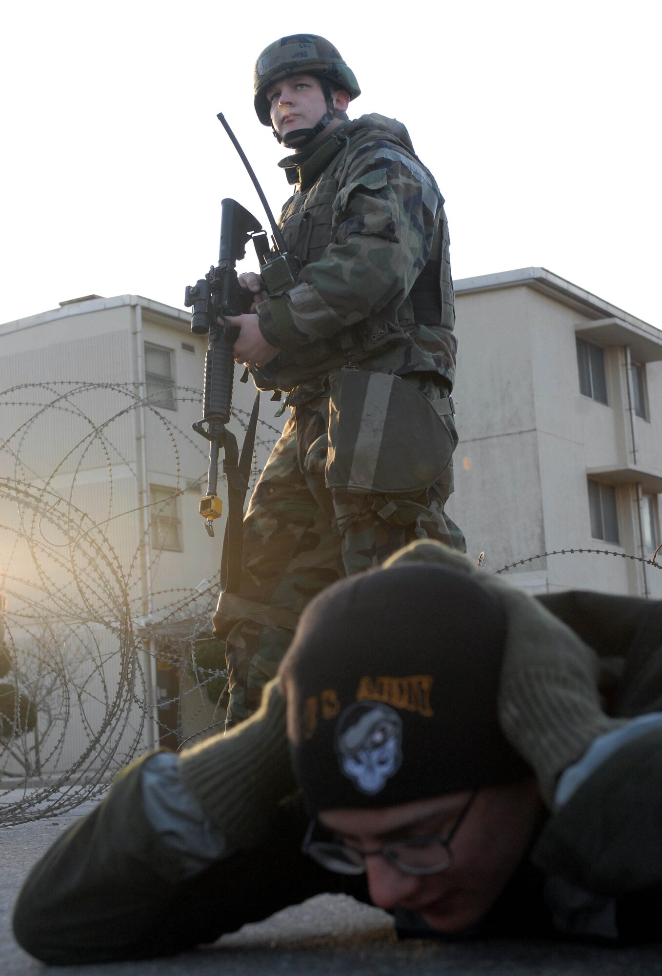 KUNSAN AIR BASE, South Korea -- Senior Airman Russell Webb, 8th Security Forces Squadron, watches over a captured enemy prisoner of war after a simulated attack on the Wing Operations Center during the peninsula wide operations readiness exercise here Jan. 17. The exercise is conducted to ensure members of the Wolf Pack remain ready to execute its mission of "Defending the Base, Accepting Follow on Forces and Taking the Fight North." (U.S. Air Force photo/Senior Airman Steven R. Doty)