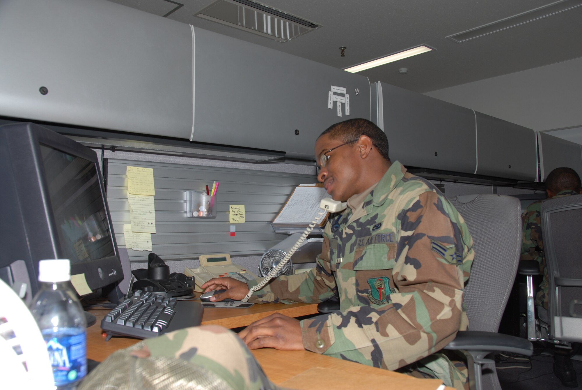 MISAWA AIR BASE, Japan -- Airman 1st Class Kennith Holley, 35th Communications Squadron, sits at his desk in the voice network systems flight Jan. 17, 2008. Airman Holley won tickets to the Super Bowl in Phoenix, Ariz. from the Air Force Services Agency's "Football Frenzy." His coworker won tickets to the Pro Bowl in the same contest. (U.S. Air Force photo by Senior Airman Stefanie Torres)