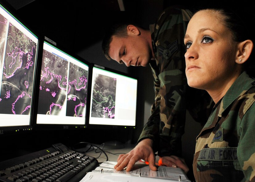 Senior Airman Cassandra Napolitano-Romero, from Lynchburg, Va., and Senior Airman Steven Stolze, from Brainard, Neb., go over Meteorological Satellite imagery. Both are METSAT analysts with the 2nd Weather Squadron at Offutt Air Force Base, Neb. (Photo  by G. A. Volb)