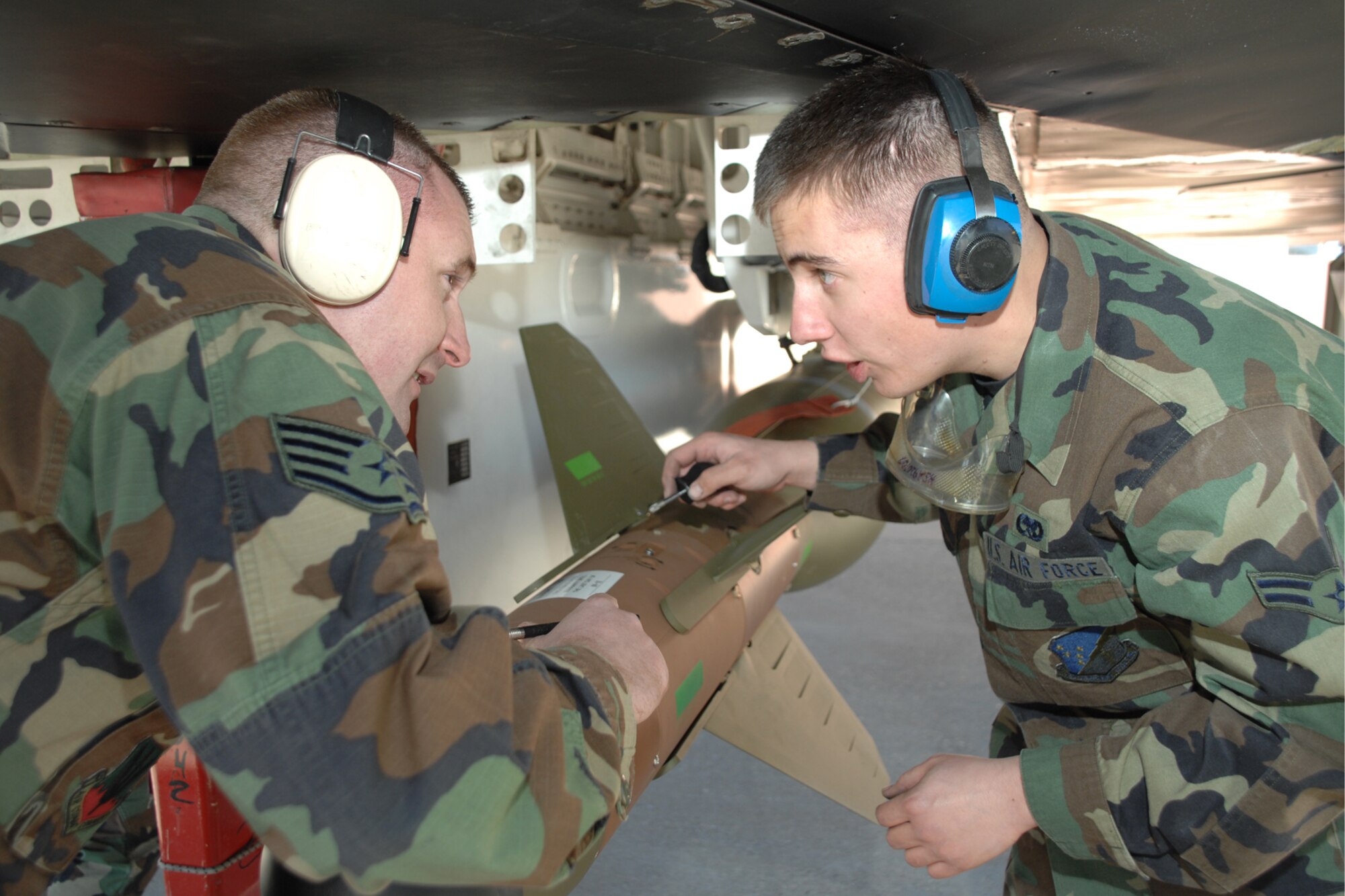 Staff Sgt. Christopher Osterholm and Airman 1st Class Corey Colombari, both of the 49th Maintenance Squadron, discuss loading operations during a F-117A Weapons Load Crew of the Year Competition Jan. 18, 2008, at Holloman Air Force Base, N.M. The competition is the last for the F-117A as Holloman is scheduled to retire the Nighthawk and bring in the F-22A Raptor. (U.S. Air Force photo/Airman 1st Class Jamal D. Sutter)