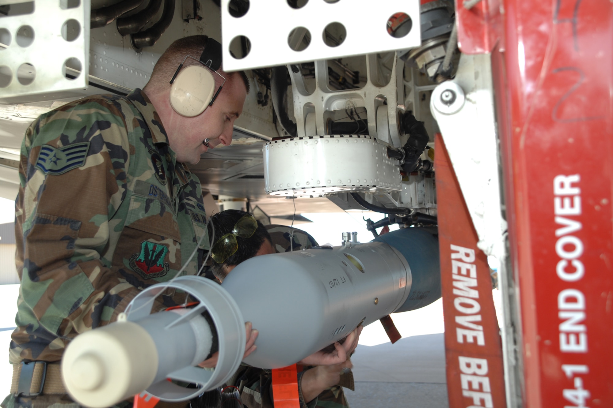 Staff Sgt. Christopher Osterholm, 49th Maintenance Squadron, helps his teamate load a GBU-12 during a F-117A Weapons Load Crew of the Year Competition Jan. 18, 2008, at Holloman Air Force Base, N.M. Seargent Osterholm and teammates, Senior Airman Gino Colombari and Airman 1st Class Corey Carlson,  represented the 9th Aircraft Maintenance Unit. (U.S. Air Force photo/Airman 1st Class Jamal D. Sutter)