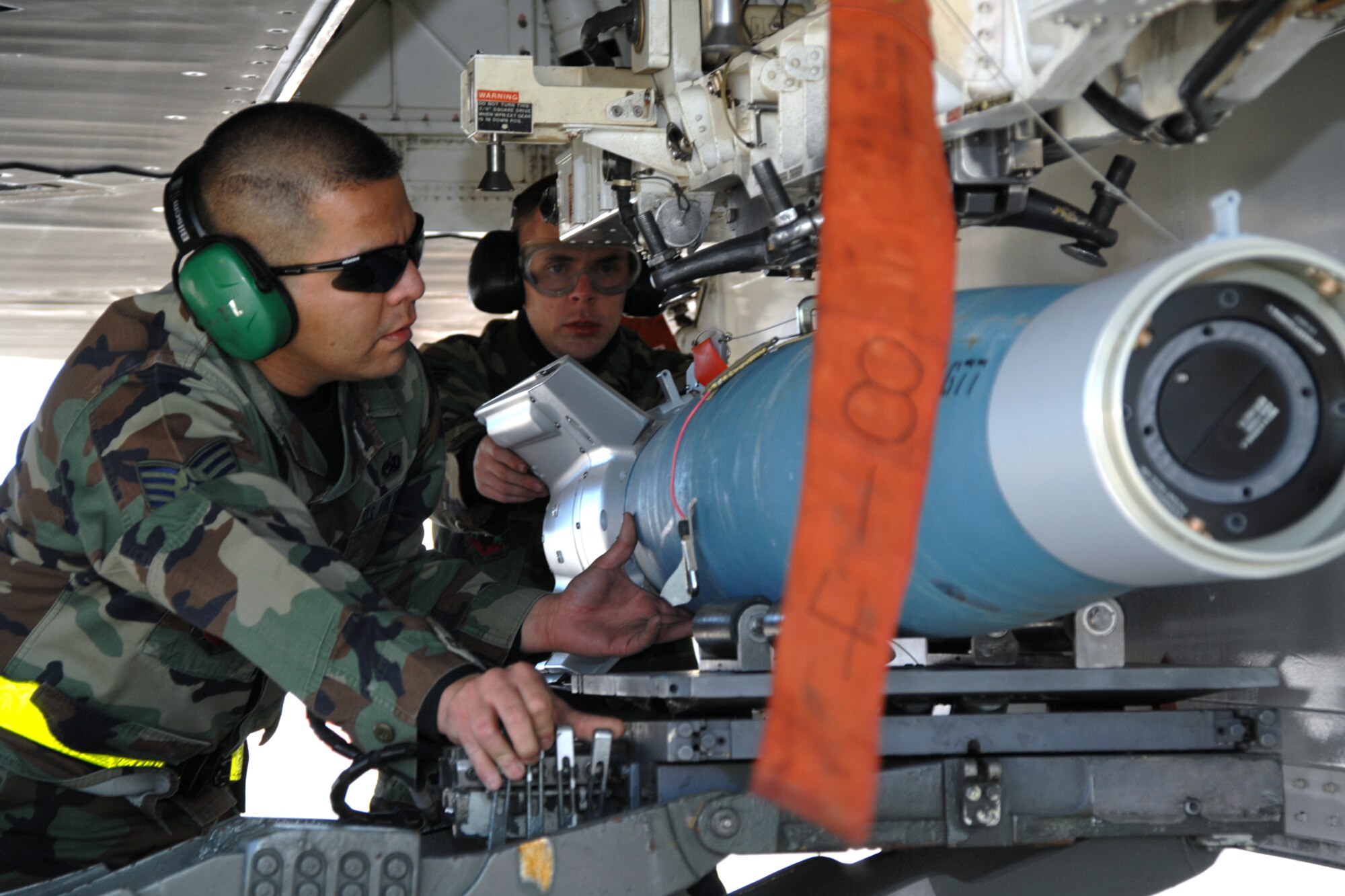 Staff Sgt. Alberto Vazquez and Senior Airman Adam Evans, both of the 49th Aircraft Maintenance Squadron, load a GBU-12 during a F-117A Weapons Load Crew of the Year Competition Jan. 19, 2008, at Holloman Air Force Base, N.M. Seargent Vazquez, Airman Evans and teammate, Airman 1st Class Ray Wornat, represented the 8th Aircraft Maintenance Unit during the competition. (U.S. Air Force photo/Airman 1st Class Jamal D. Sutter)