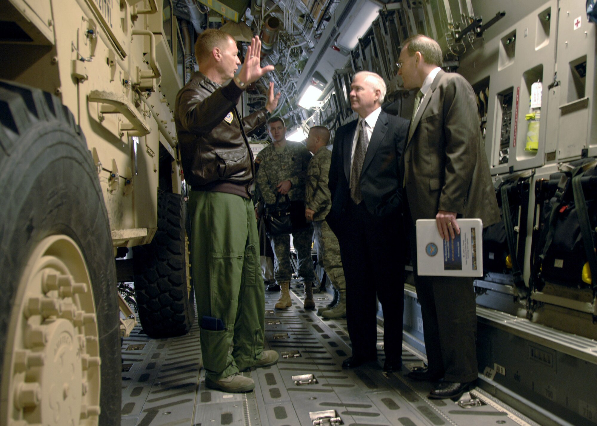 Col. John "Red" Millander, 437th Airlift Wing commander, Charleston AFB, S.C., explains the loading procedures of the Mine Resistant Ambush Protected Vehicles on C-17 aircraft to the Secretary of Defense, The Honorable Robert Gates, on Charleston AFB Jan. 19. (U.S. Air Force photo/Airman 1st Class Katie Gieratz)