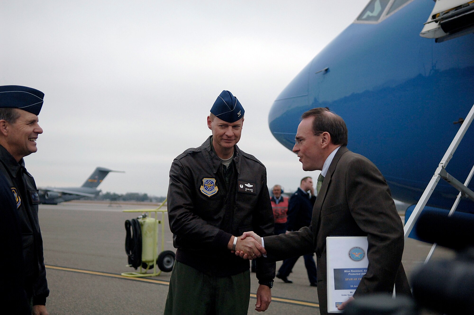 Col. John "Red" Millander, 437th Airlift Wing commander, Charleston AFB, S.C., greets a member of the Secretary of Defense?s staff as he comes of his aircraft and steps onto the Charleston AFB flightline Jan. 18.  The secretary viewed the loading procedures of the Mine Resistant Ambush Protected Vehicles on a C-17 aircraft, and he also toured the integration, testing and installation of advanced electronic systems on the MRAP vehicles at the Space and Naval Warfare Systems Center Charleston, S.C. (U.S. Air Force photo/Senior Airman Nicholas Pilch)