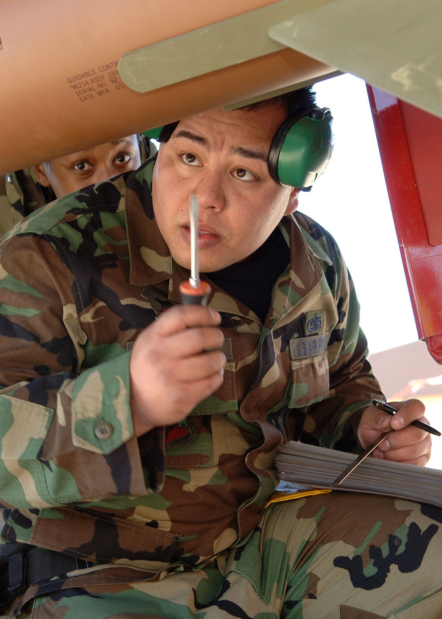 Staff Sgt. Jose Cortez of the 49th Aircraft Maintenance Squadron tightens a screw on the GBU-27 while Senior Airman Arinda Murphy looks during the Weapons Load Crew of the Year Competition on Holloman Air Force Base, N.M., Jan.18, 2008. This is the final Weapons Load Crew of the Year Competition for the F-117A  on Holloman. (U.S. Air Force photo/Airman 1st Class John D. Strong II) 