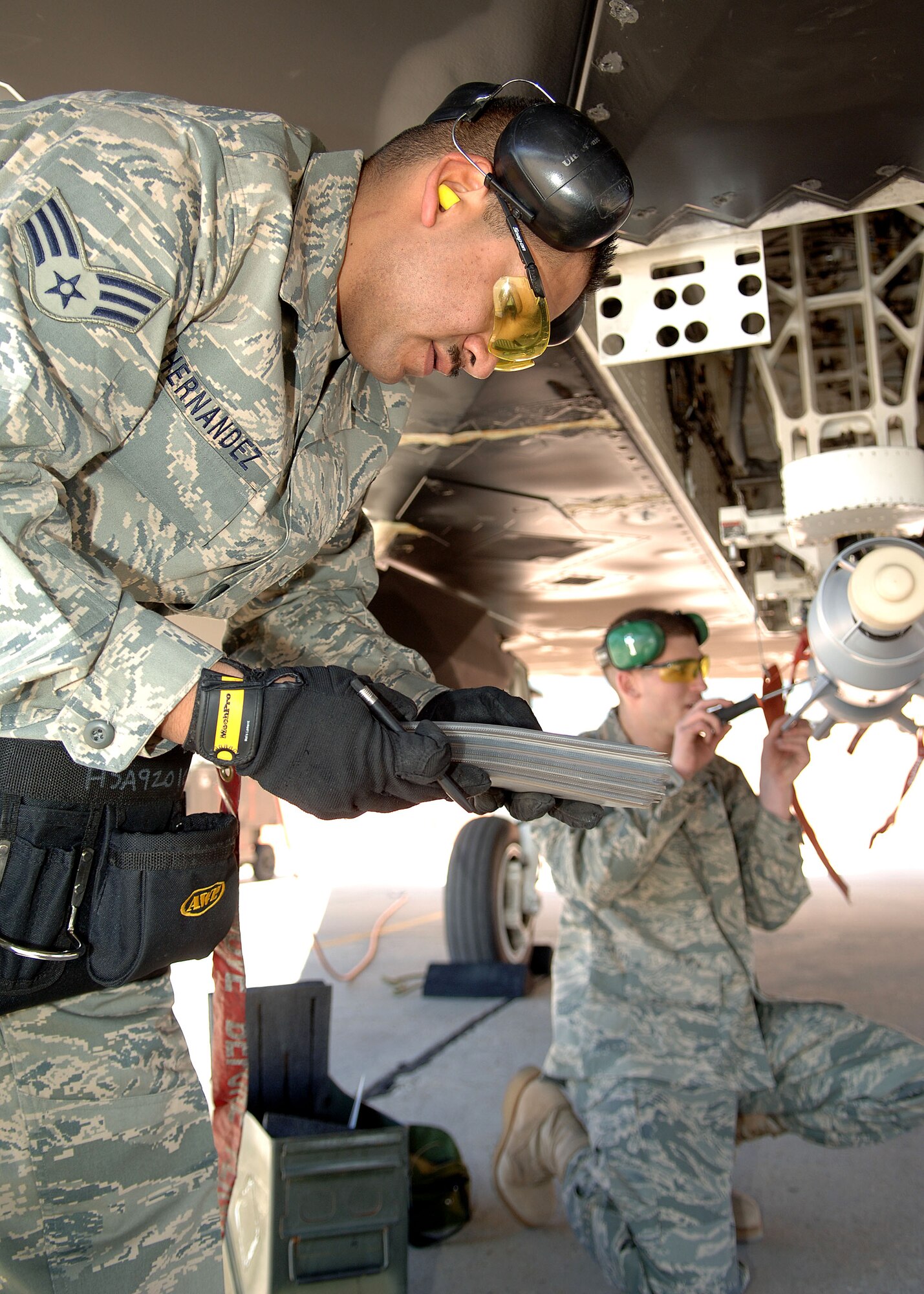 Senior Airman Ignacio Hernandez and Airman 1st Class Kyle Davey of the 49th Aircraft Maintenance Squadron finish their final check on the GBU-12 during the Weapons Load Crew of the Year Competition on Holloman Air Force Base, N.M., Jan.18, 2008. This is the final Weapons Load Crew of the Year Competition for the F-117A on Holloman. (U.S. Air Force photo/Airman 1st Class John D. Strong II)  