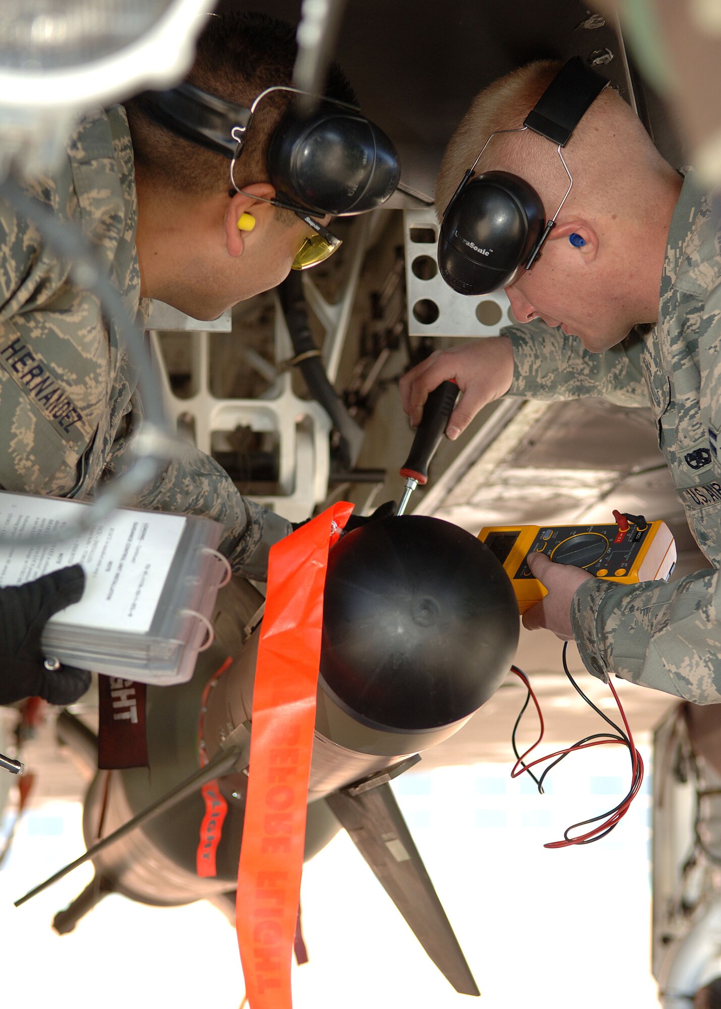 Senior Airman Ignacio Hernandez and Airman 1st Class Kyle Palmateer of the 49th Aircraft Maintenance Squadron perform their final checks on the GBU-27 during the Weapons Load Crew of the Year Competition on Holloman Air Force Base, N.M., Jan.18, 2008. This is the final Weapons Load Crew of the Year Competition for the F-117A on Holloman. (U.S. Air Force photo/Airman 1st Class John D. Strong II)  