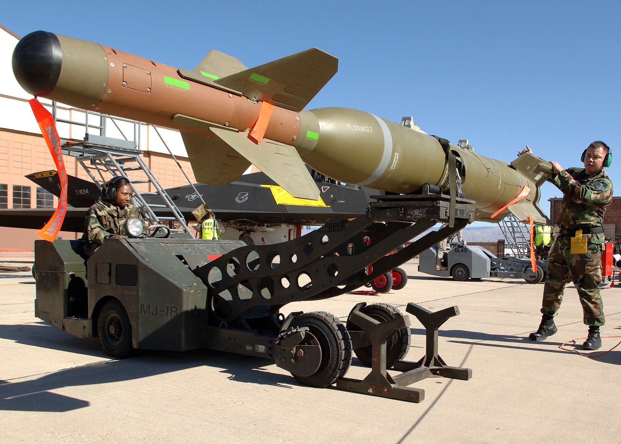 Senior Airman Arinda Murphy and Staff Sgt. Jose Cortez of the 49th Aircraft Maintenance Squadron move the GBU-27 from its stand during the Weapons Load Crew of the Year Competition on Holloman Air Force Base, N.M., Jan.18, 2008. This is the final Weapons Load Crew of the Year Competition for the F-117A on Holloman. (U.S. Air Force photo/Airman 1st Class John D. Strong II)  