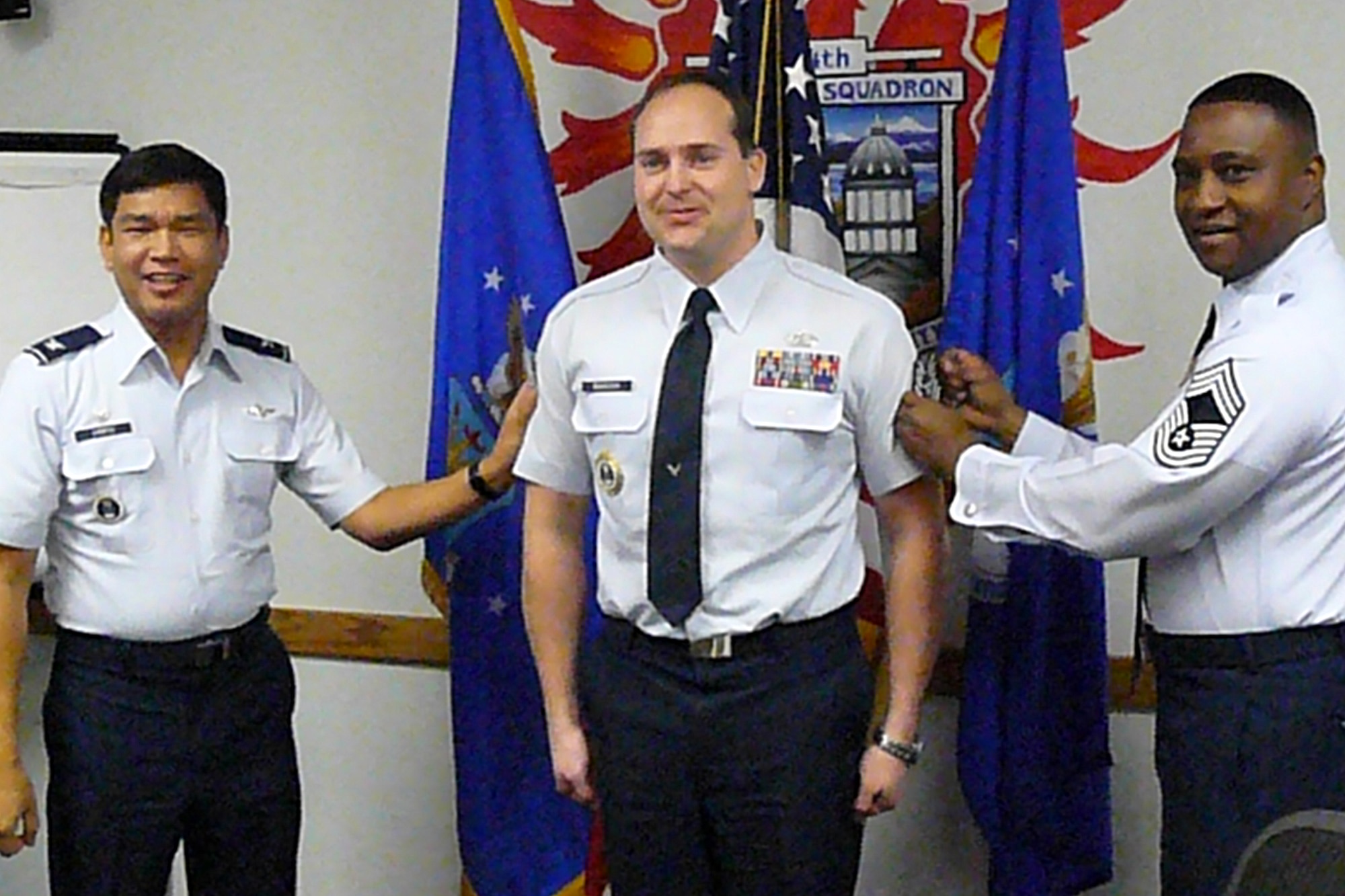 Staff Sgt. Joseph J. Babcock received an early bump in pay by getting STEP promoted to technical sergeant, recently.  Col. Mariano Campos, 372nd Recruiting Group commander, officiated and led tacking on Babcock's new stripes accompanied by Chief Master Sgt. Lester Harvey (Air Force photo)