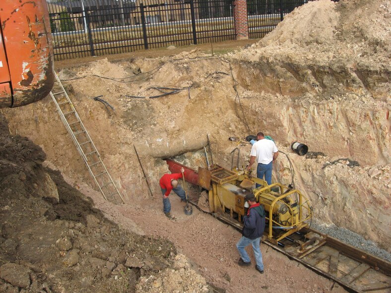 Contractors from the 23rd Civil Engineer Squadron use a jack and bore process to insert a 16-inch casing under Bemiss Road as part of a permeate water pipeline construction project that will use concentrate water to irrigate Quiet Pines Golf Course. This project will save more than nine-million gallons of water annually. (U.S. Air Force image by Mike Gruber) 
