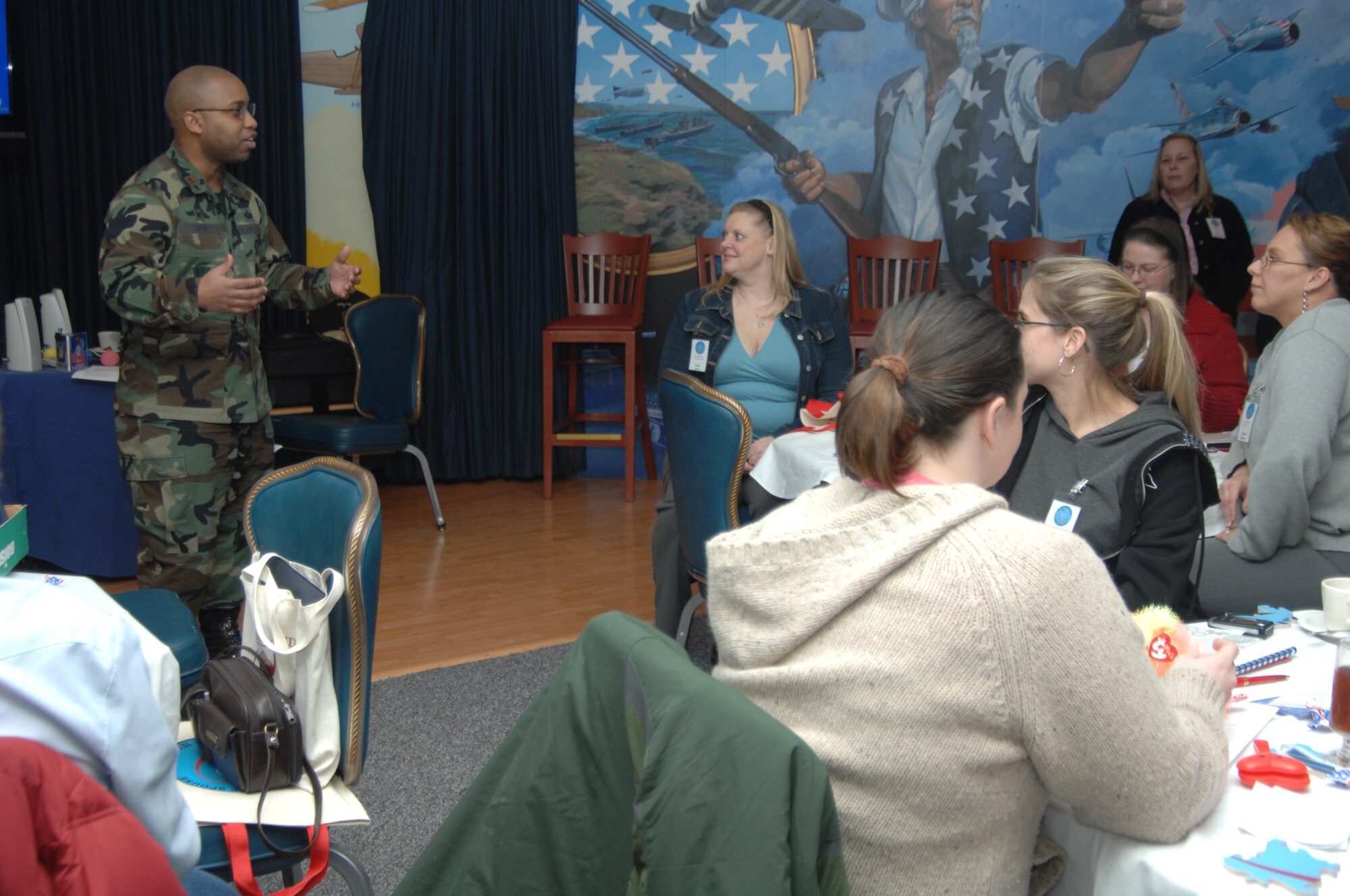 MOUNTAIN HOME AIR FORCE BASE, Idaho -- Maj. Roland Akin III, 366th Mission Support Group commander, congratulates spouses on graduating from the Airmen and Family Readiness Center's Heart Link class at the Gunfighter Club here Jan. 11. Each quarter, spouses new to the base have the opportunity to attend the class to get familiarized with what the base has to offer and learn about life in the Air Force. (U.S. Air Force photo/Airman 1st Class Samantha S. Crane)