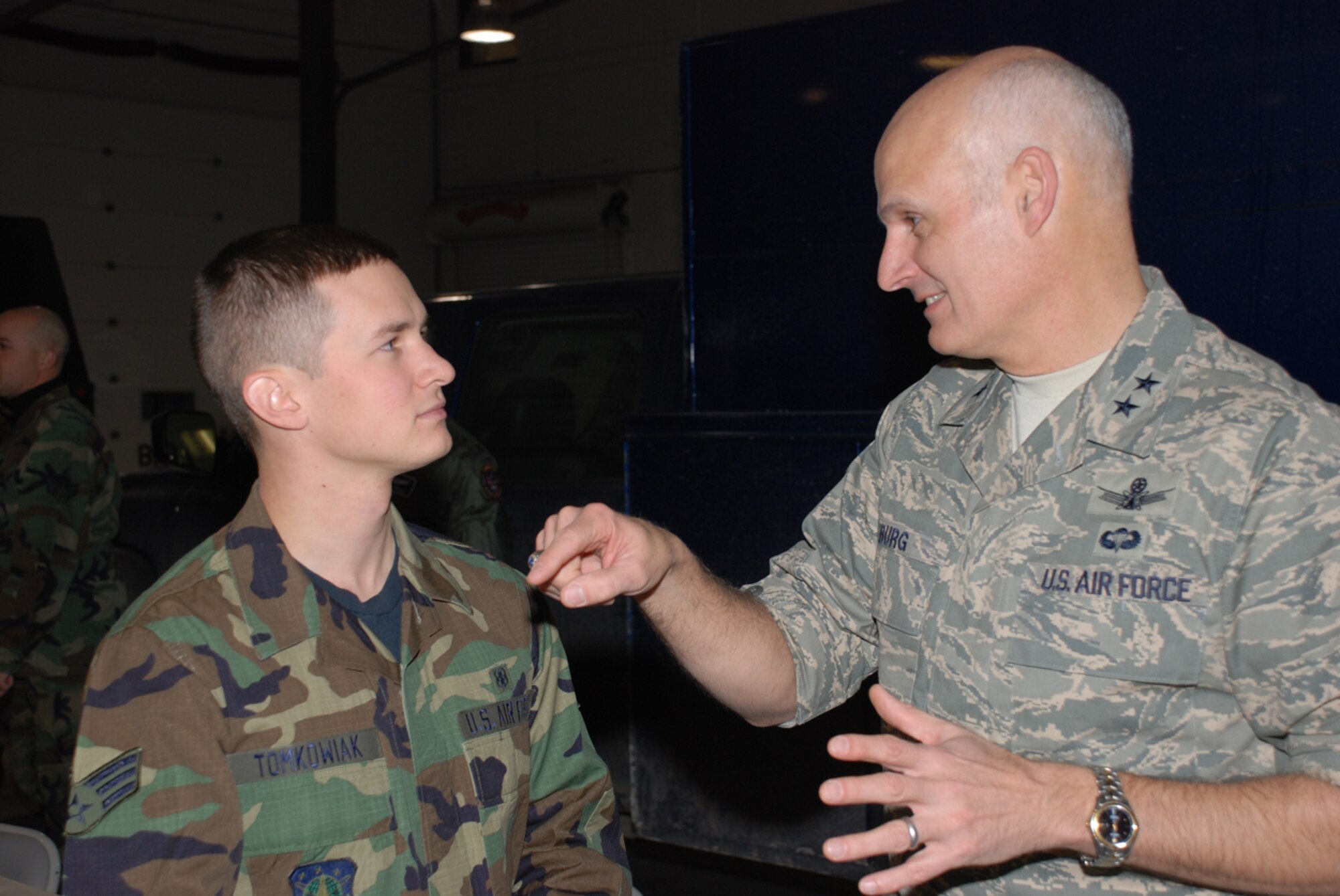 Maj. Gen. Roger W. Burg, Twentieth Air Force commander, talks with Senior Airman Glen Tomkowiak, 90th Medical Support Squadron, during breakfast for the general’s visit at Warren (U.S. Air Force photo/Airman 1st Class Daryl Knee).