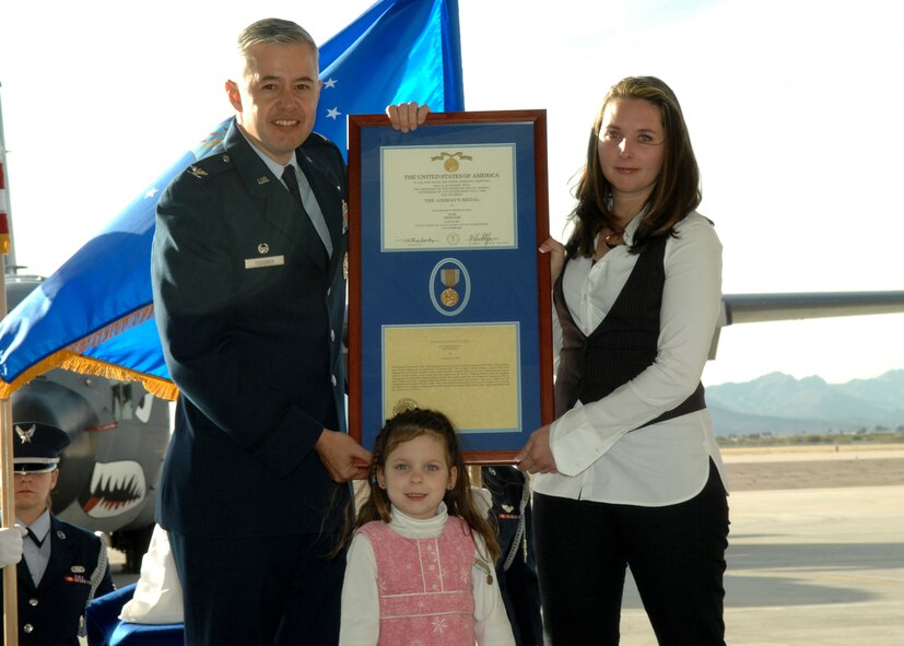 Colonel Kenneth Todorov, Commander 23rd Wing, presents Candice Hahn and Abriana Hahn, wife and daughter of Staff Sgt. Timothy R. Hahn, with the Airman's Medal and Certificate here, January 16, 2008. Staff Sgt. Hahn was awarded the Airman's Medal for attempting to rescue a woman caught in harm's way during an unexpected flash flood, losing his life in the process. (U.S. Air Force photo/Airman 1st Class Noah R. Johnson)