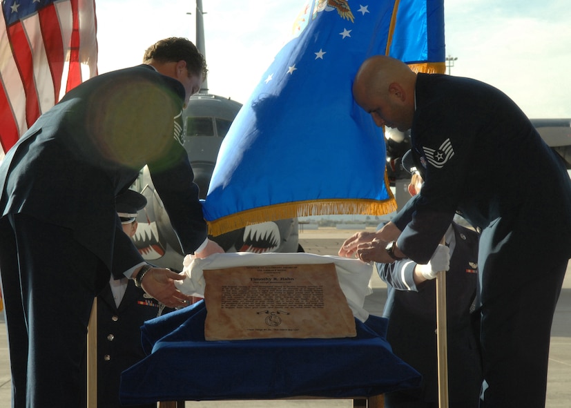 Members of the 79th Aircraft Maintenance Unit unveil the Airman's Medal Memorial for Staff Sgt. Timothy R. Hahn here, January 16, 2008. (U.S. Air Force photo/Airman 1st Class Noah R. Johnson)