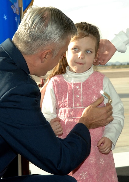 Abriana Hahn accepts the Airman's Medal from Col. Kenneth Todorov, commander of the 23rd Wing, on behalf of her father Staff Sgt. Timothy R. Hahn here, Jan. 16, 2008. Staff Sgt. Hahn was awarded the Airman's Medal for attempting to rescue a woman caught in harm's way during an unexpected flash flood, losing his life in the process. (U.S. Air Force photo/Airman 1st Class Noah R. Johnson)