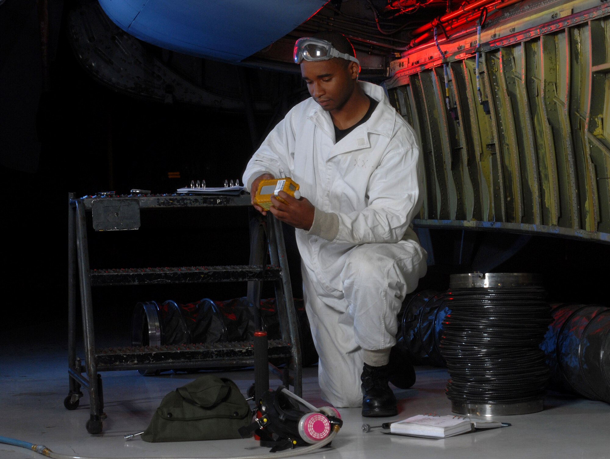 Senior Airman David Skannal checks a photo ionization detector before inspecting inside the center wing fuel tank of a KC-135 Stratotanker Jan. 9 at March Air Reserve Base, Calif. The photo ionization detector is an atmospheric monitor used to evaluate the air inside fuel tanks. Airman Skannal is a fuel cell technician from the 452nd Maintenance Squadron. (U.S. Air Force photo/Val Gempis)