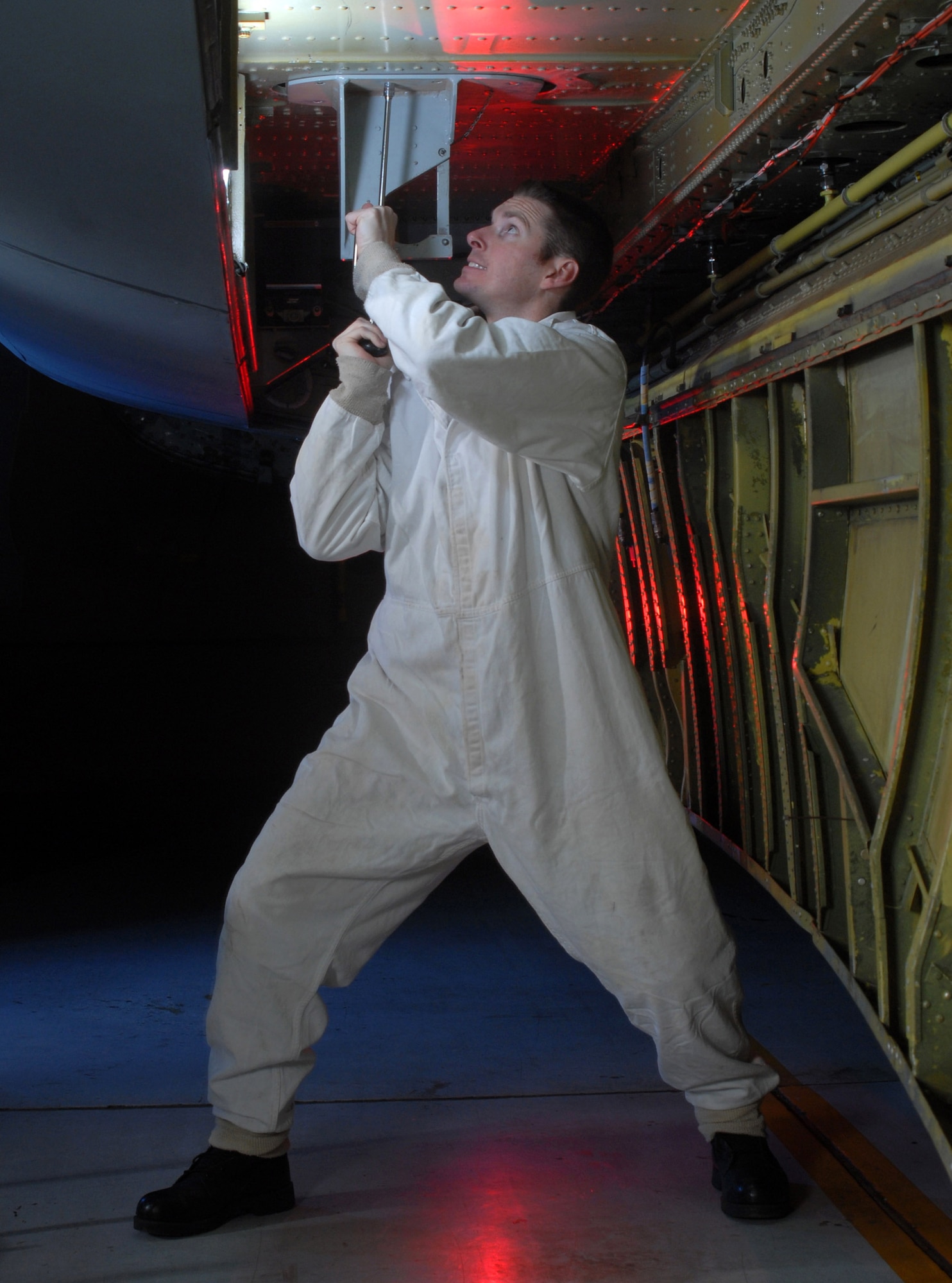 Staff Sgt. Ryan Slanina uses a speed handle to open the center wing fuel tank of a KC-135 Stratotanker during an inspection Jan. 9 at March Air Reserve Base, Calif. Sergeant Slanina is a fuel cell technician from the 452nd Maintenance Squadron. (U.S. Air Force photo by Val Gempis)