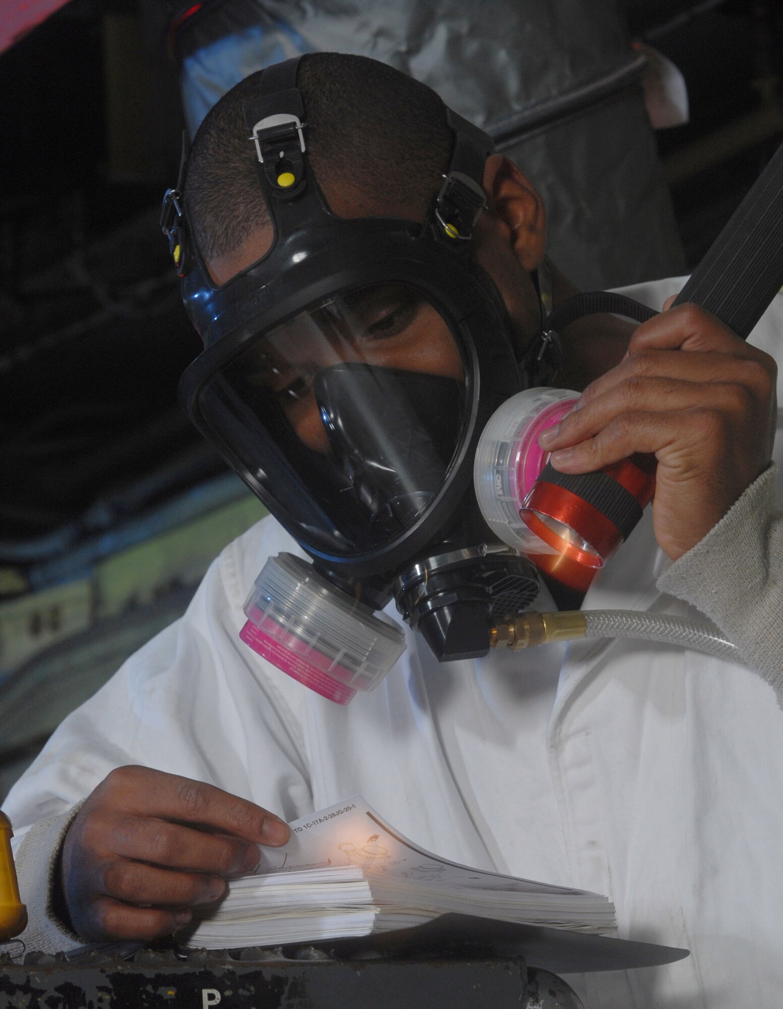 Senior Airman David Skannal refers to a technical order before inspecting a fuel tank of a KC-135 Stratotanker Jan. 9 at March Air Reserve Base, Calif. Airman Skannal is a fuel cell technician from the 452nd Maintenance Squadron. (U.S. Air Force photo/Val Gempis)